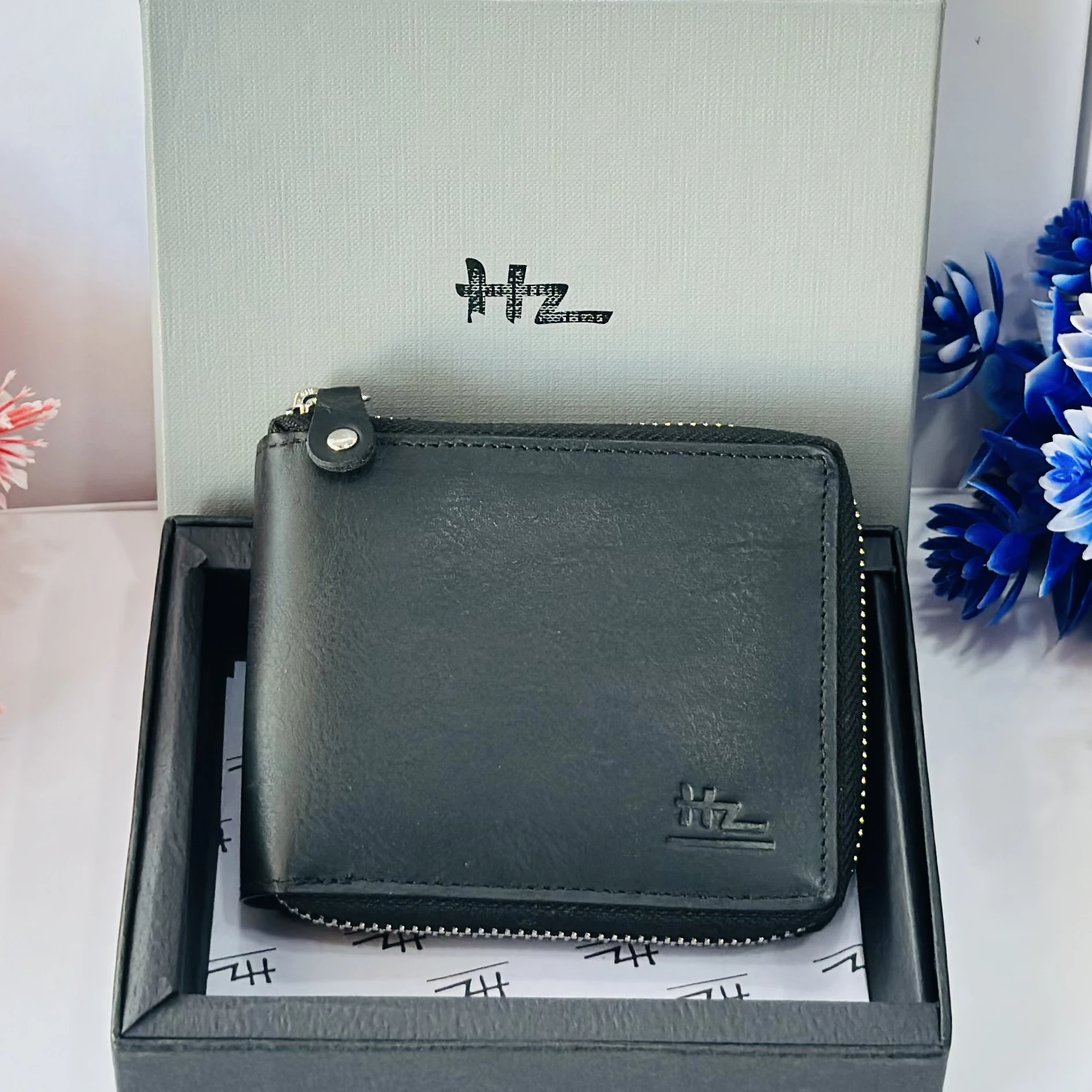 Black HZ leather zip-around wallet for men.