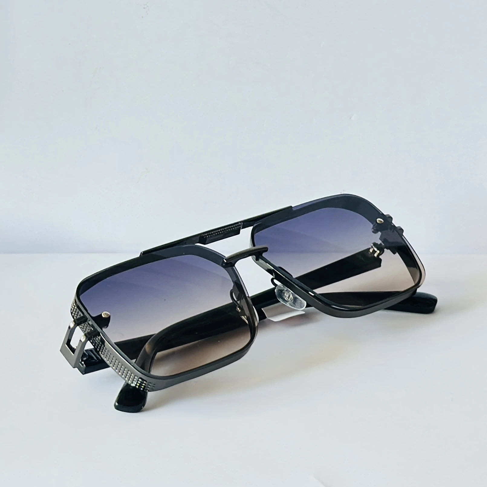 appear to be retro square or modern pilot-style sunglasses for men