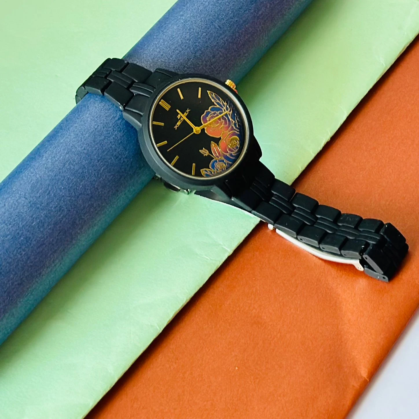 black metal analogue watch with a floral dial design