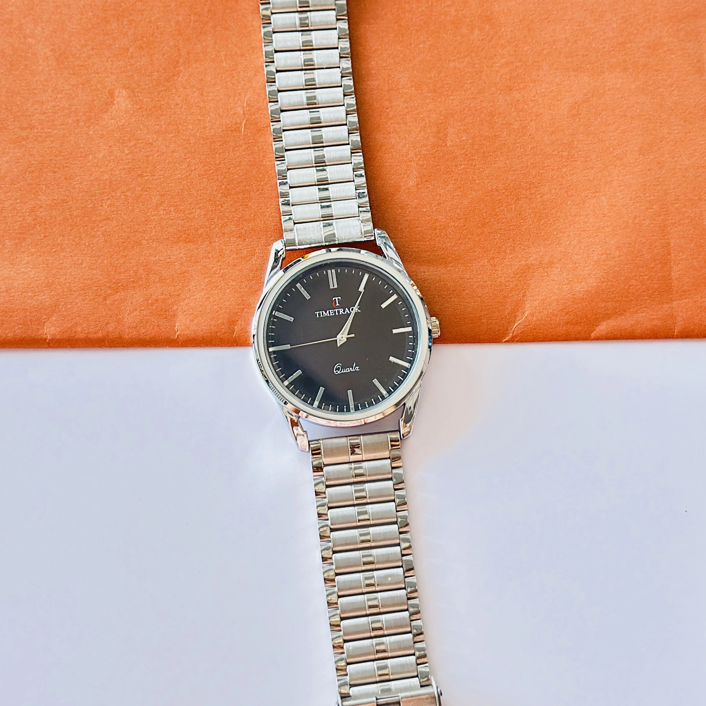 Silver coloured analogue watch