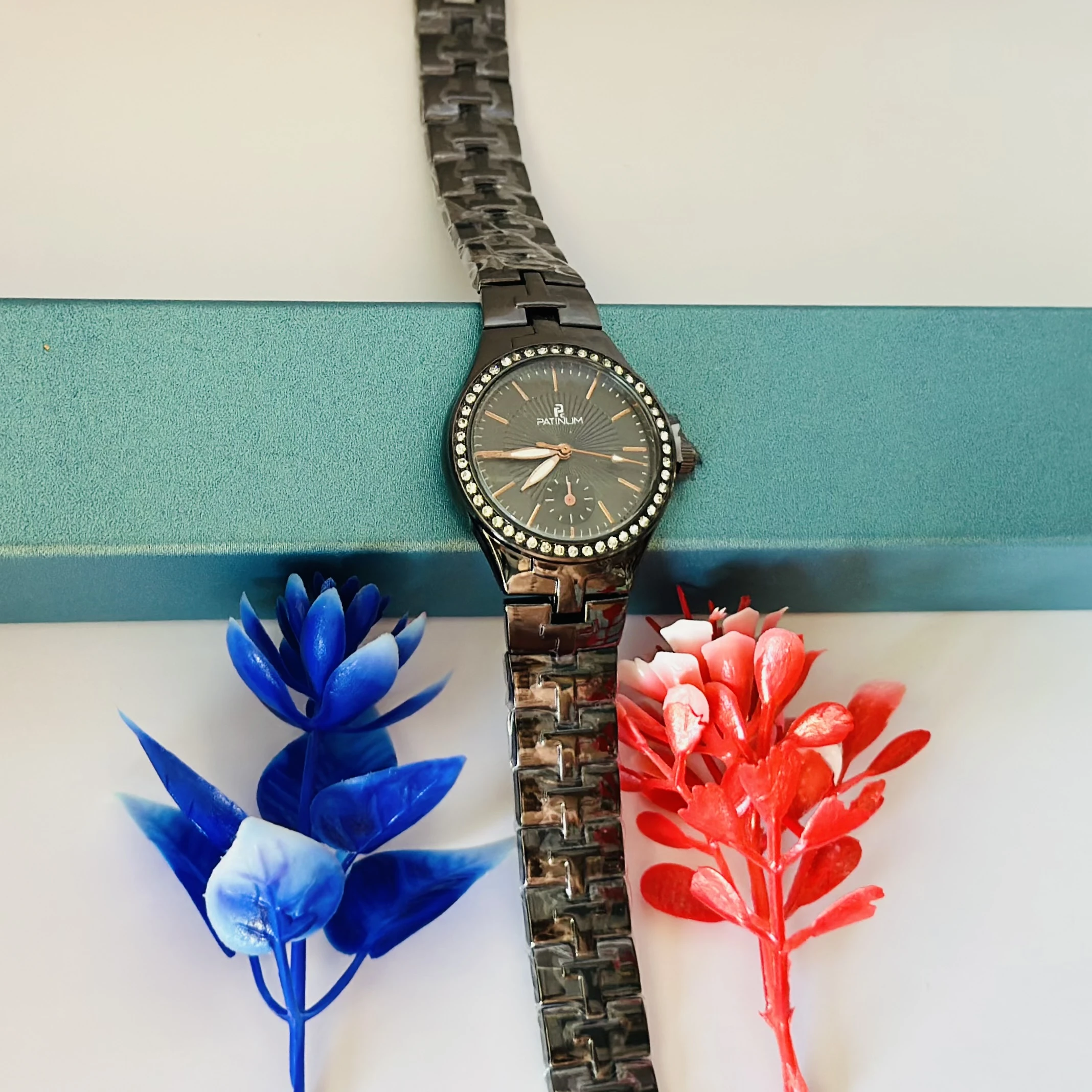 ceramic watch with a black dial and diamond-set bezel.