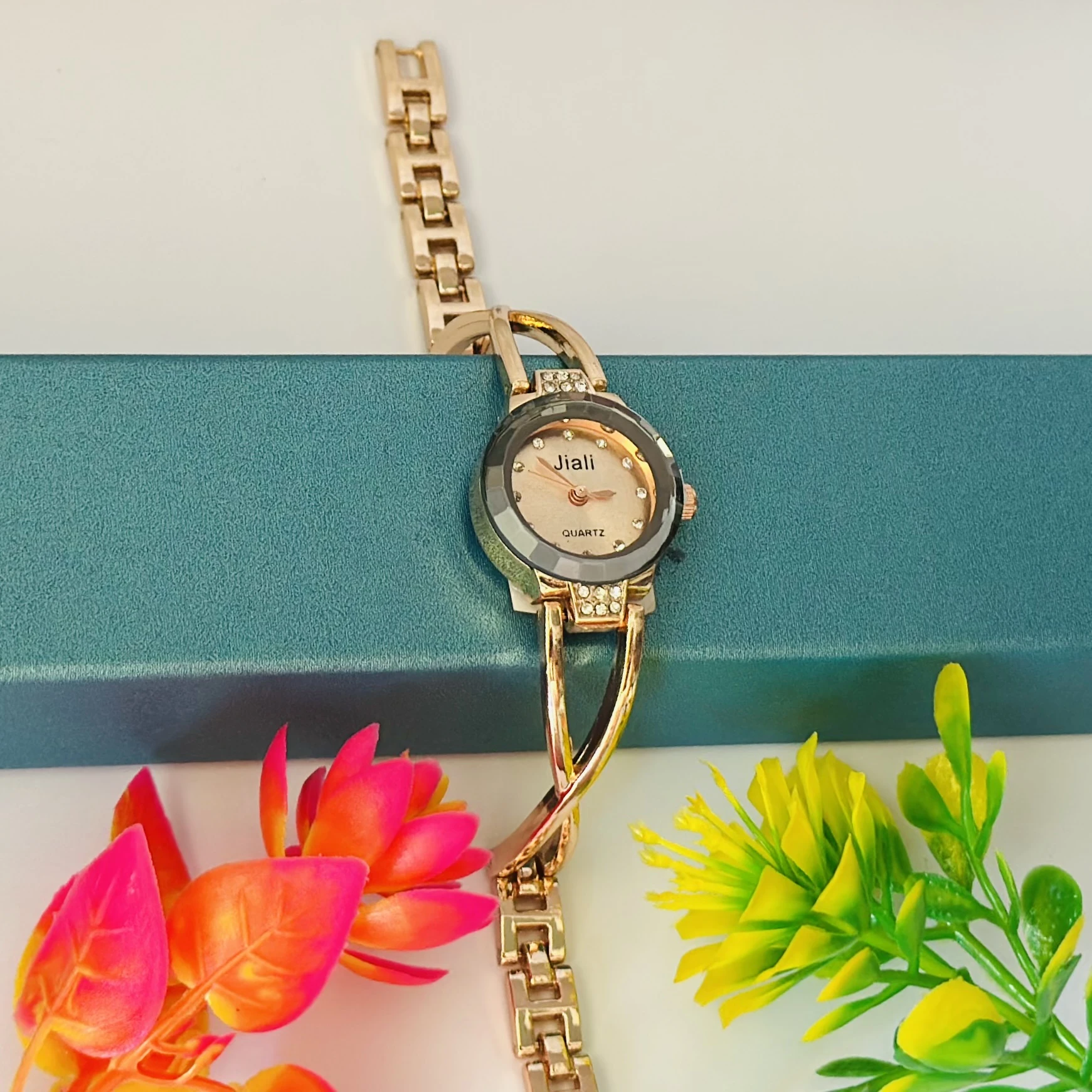 Rose gold-toned women's bracelet watch with a crystal-accented dial.