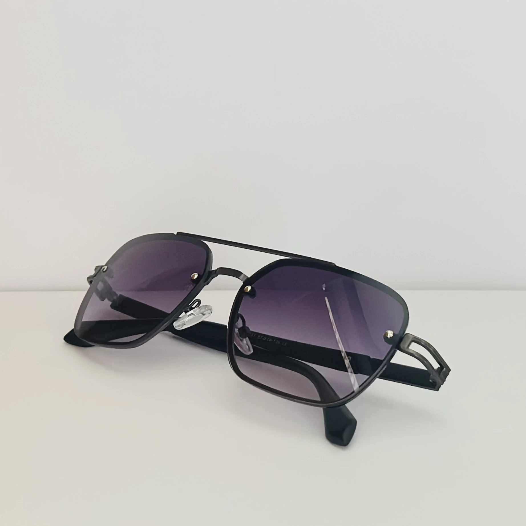pair of Maybach square-style sunglasses with a black metal frame and dark gradient lenses