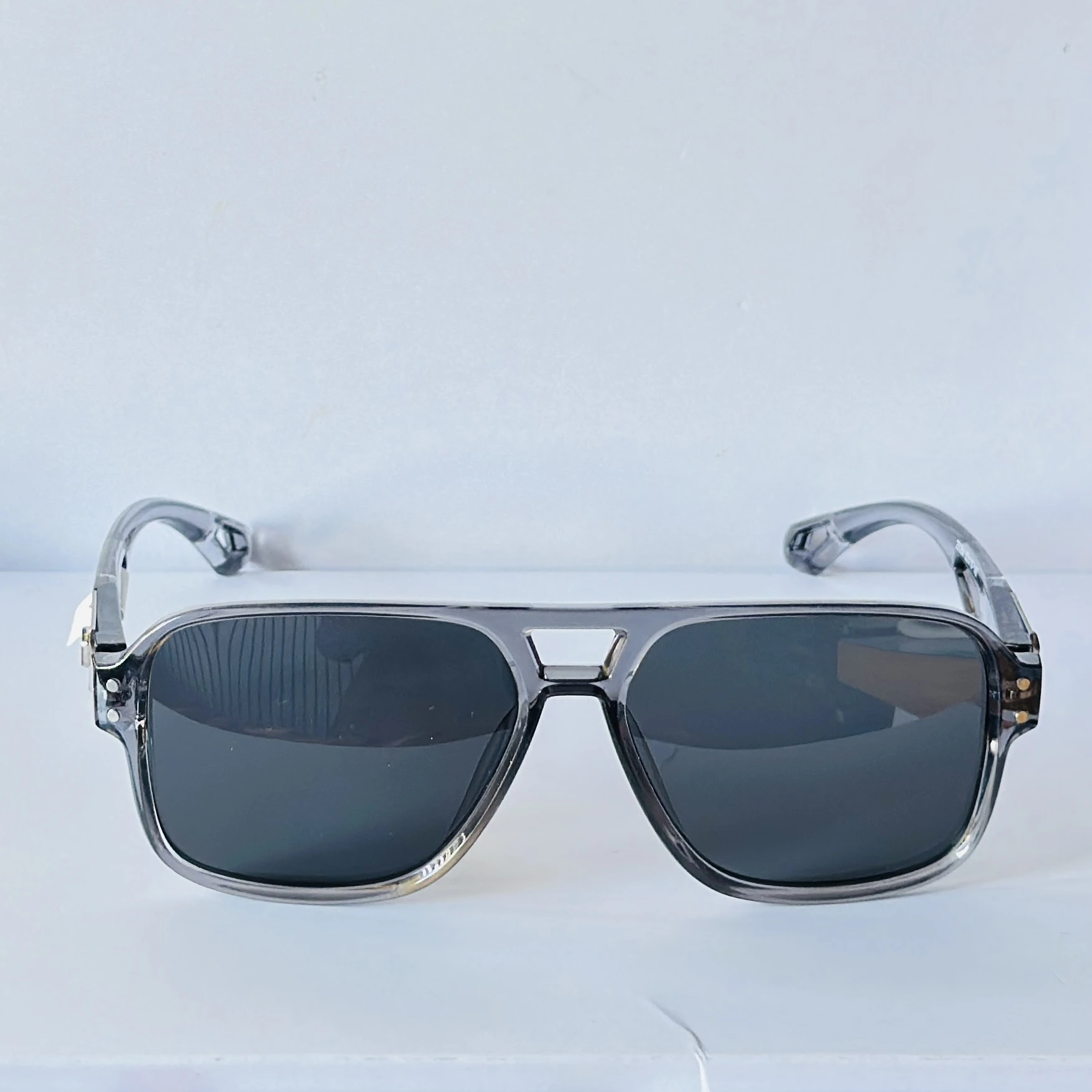 sunglasses in a transparent grey frame color.