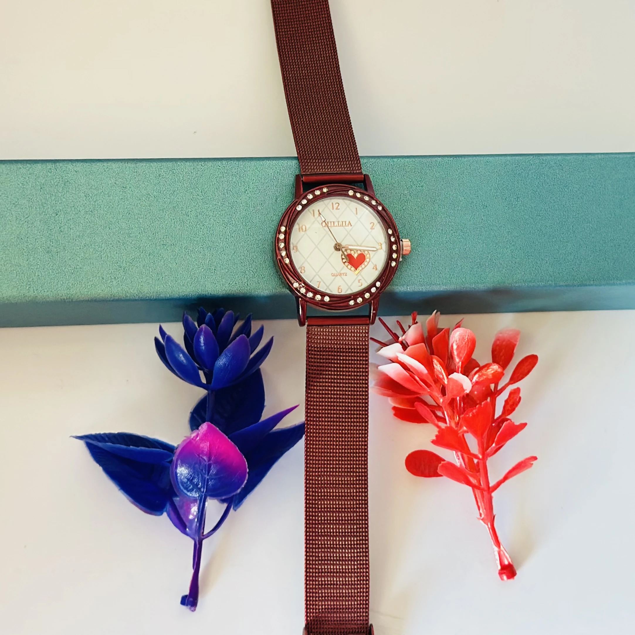 analog watch with a Red magnetic strap