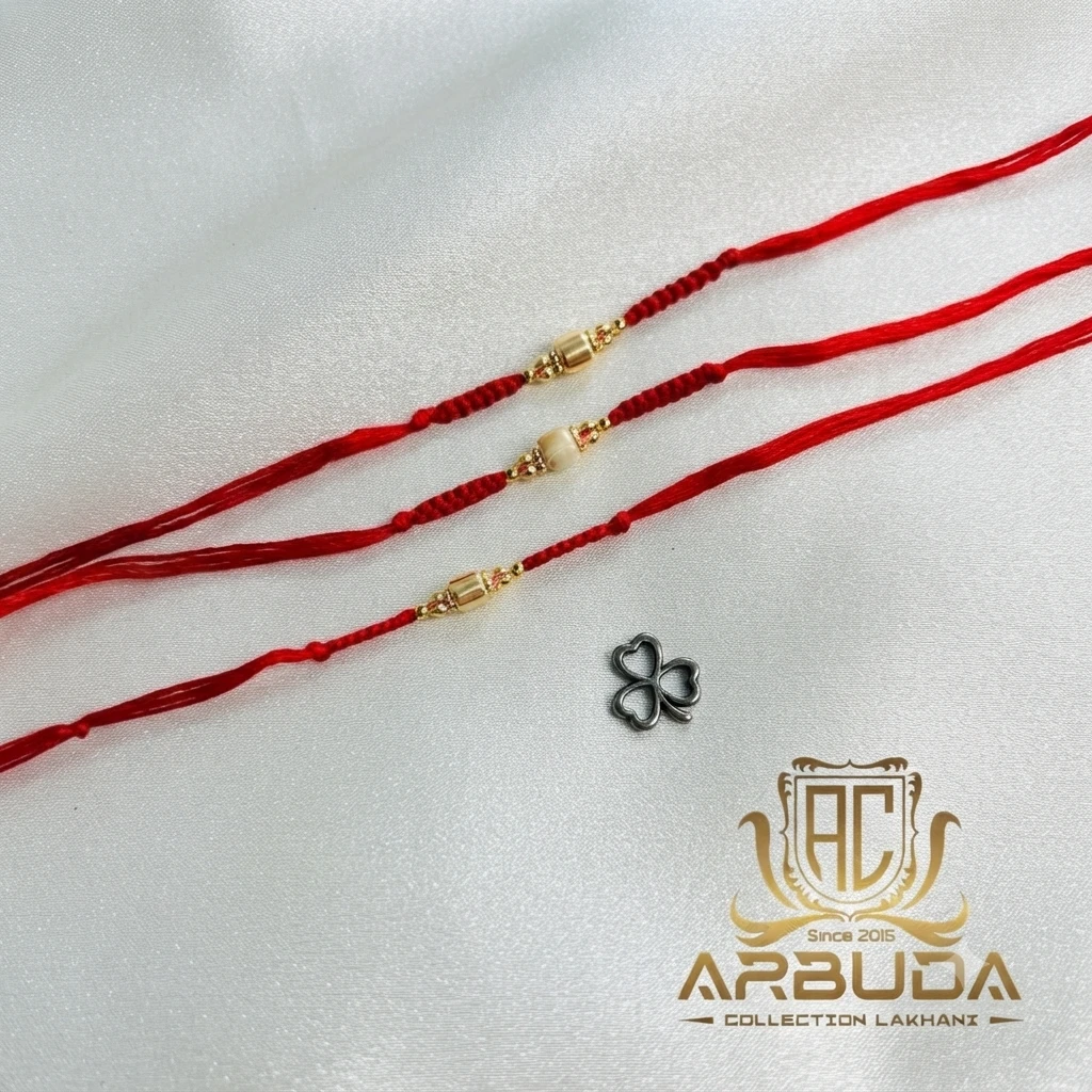 red threads adorned with central gold-plated metallic beads.