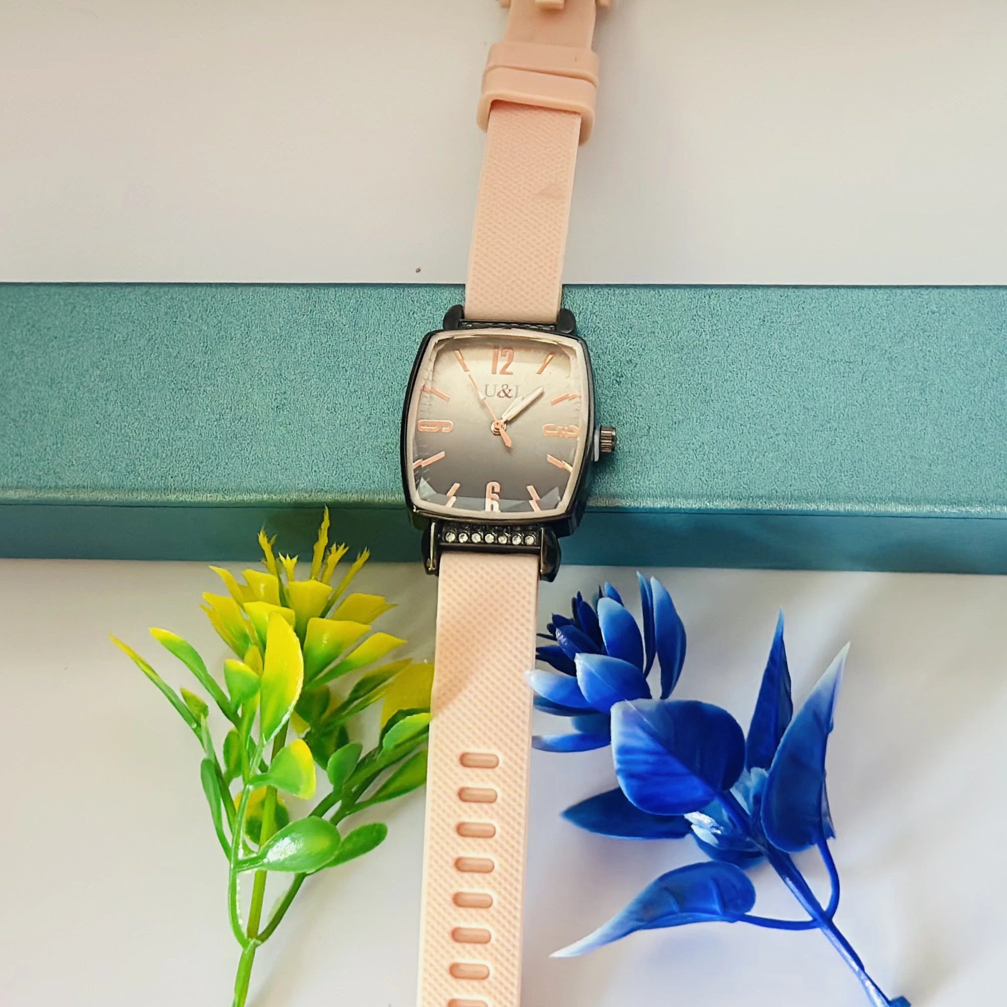women's analog watch with a pink silicone strap and a rose gold-tone case and dial
