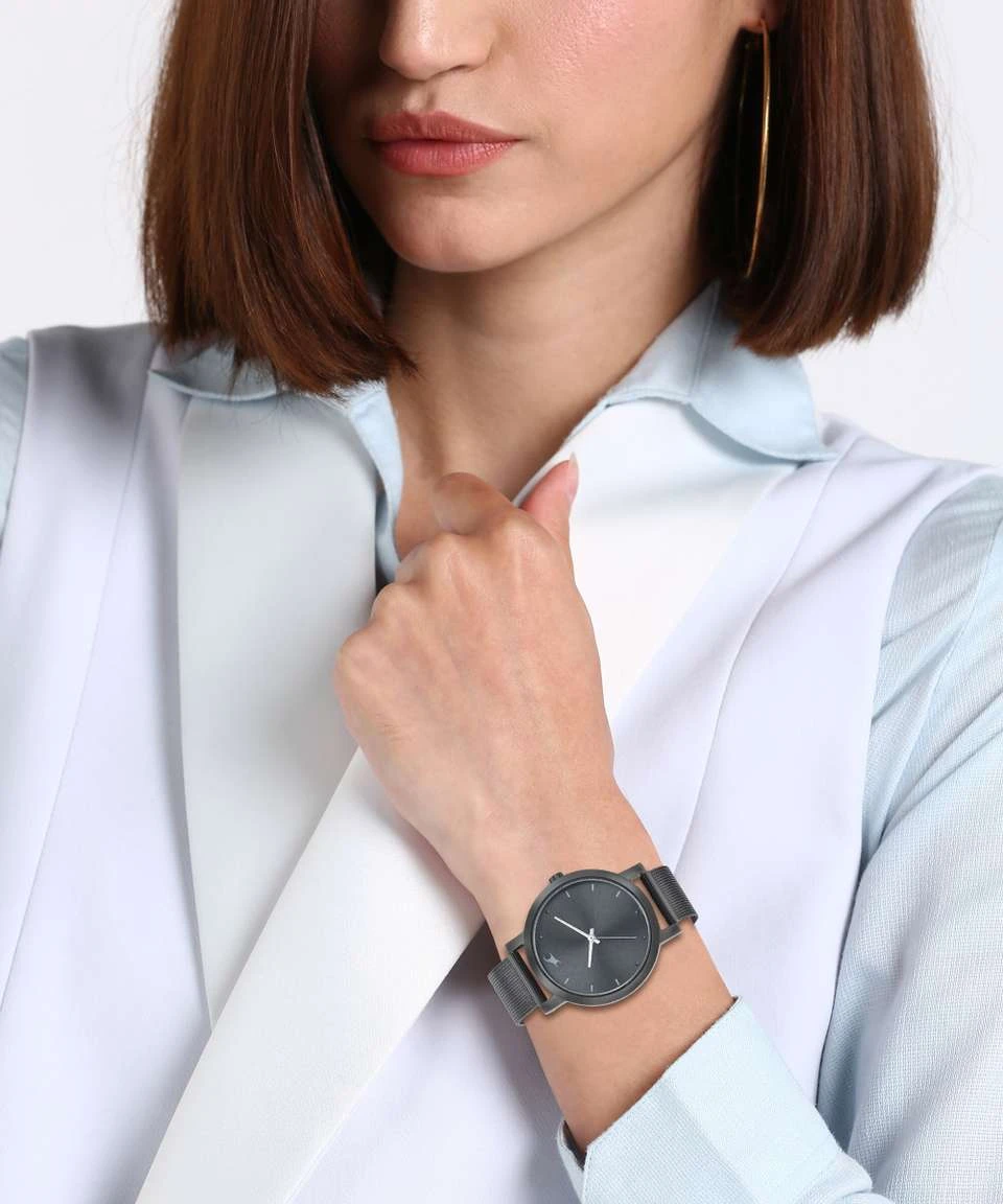 Fastrack Fleek Analog Watch featuring a sleek black dial and a matching black stainless steel mesh strap.