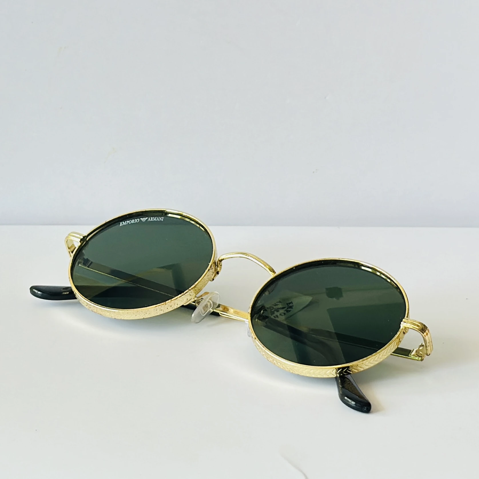 sunglasses are Emporio Armani round-frame