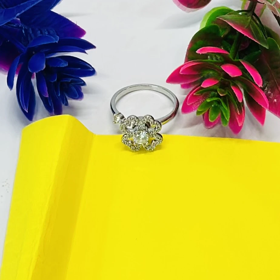 An adjustable silver-toned flower ring