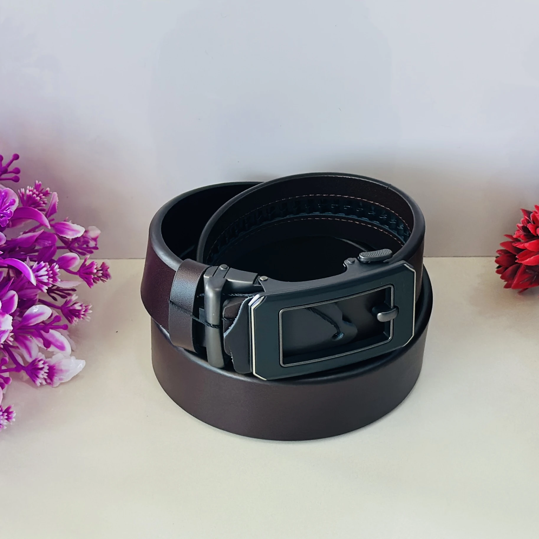 Brown leather auto-lock or ratchet buckle belt for men.