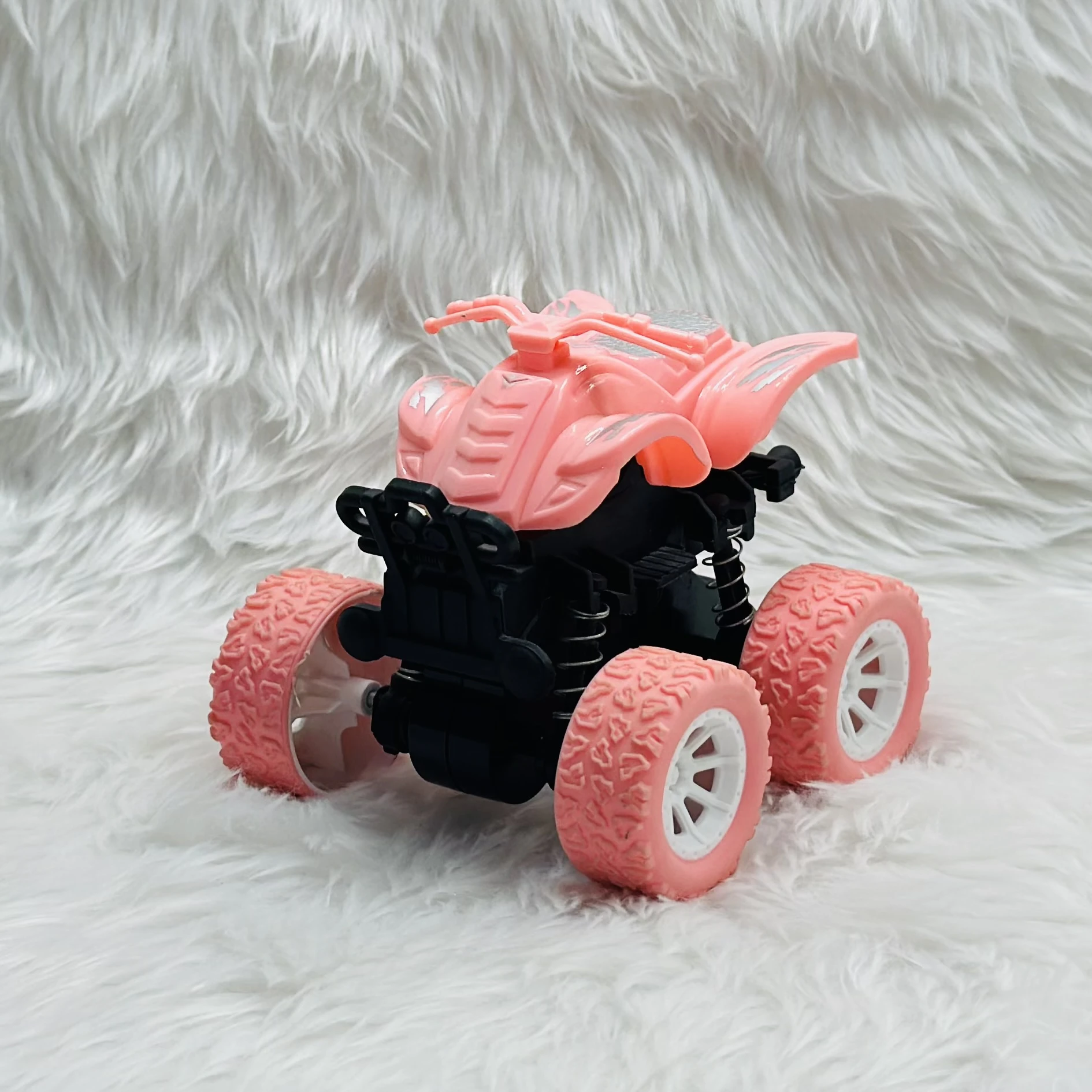 pink toy monster truck, specifically a friction-powered, four-wheel-drive inertia car.