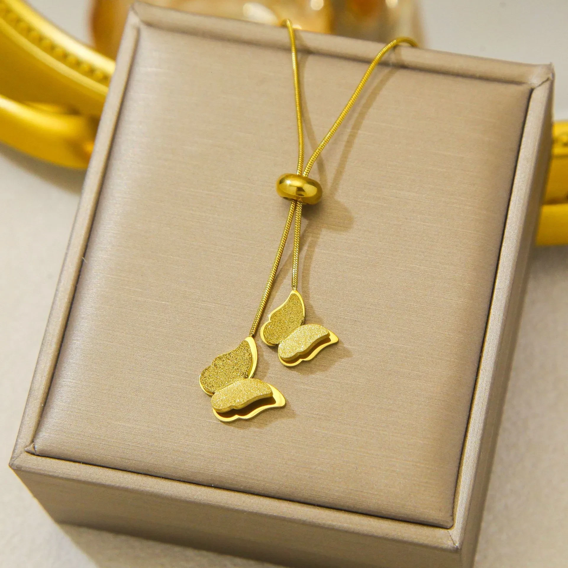 Gold -plated stainless steel necklace features a delicate butterfly drop design