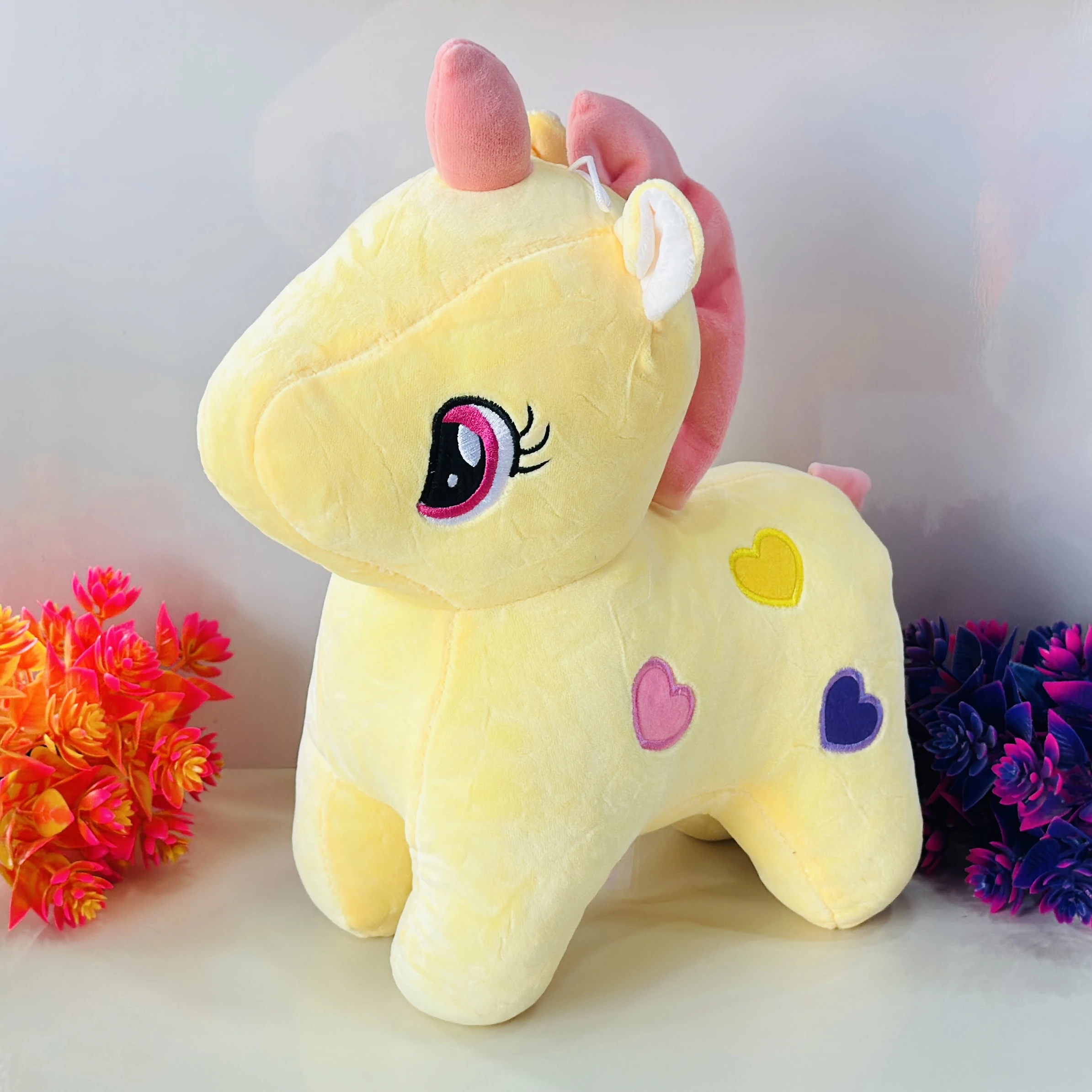 Yellow plush unicorn soft toy
