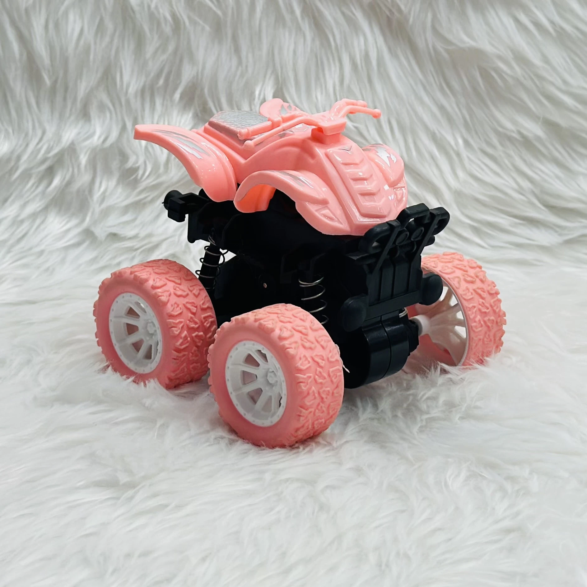 pink toy monster truck, specifically a friction-powered, four-wheel-drive inertia car.