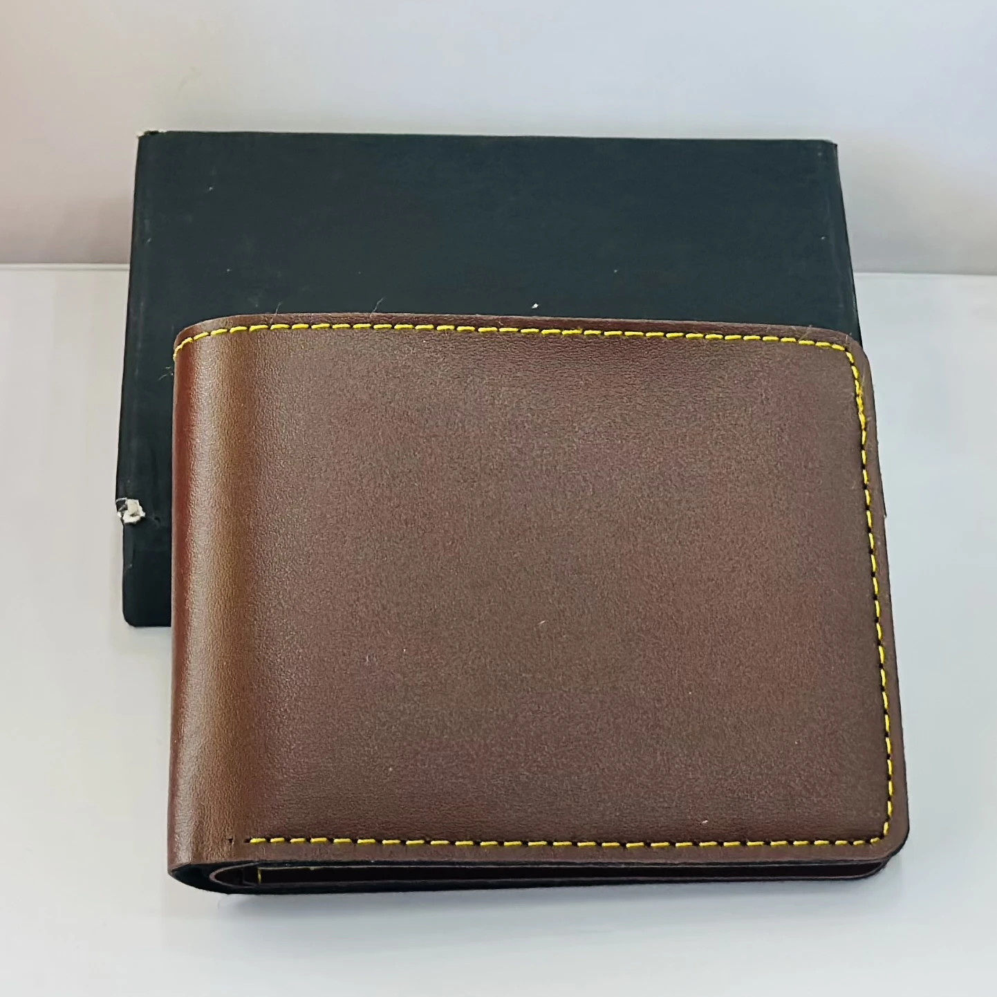 Crusset men's brown bi-fold wallet made of PU material.