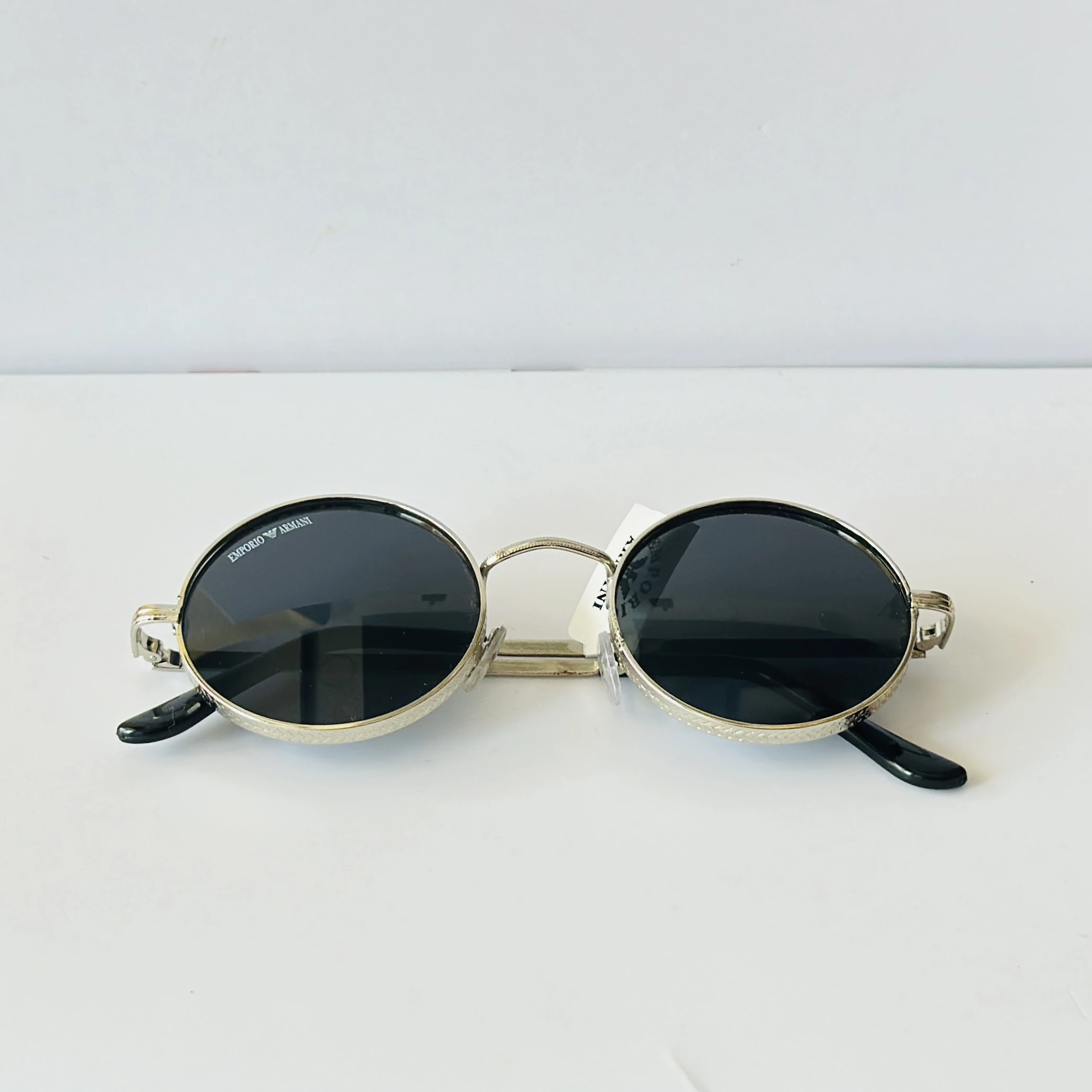 Emporio Armani sunglasses feature a distinctive round metal frame design.