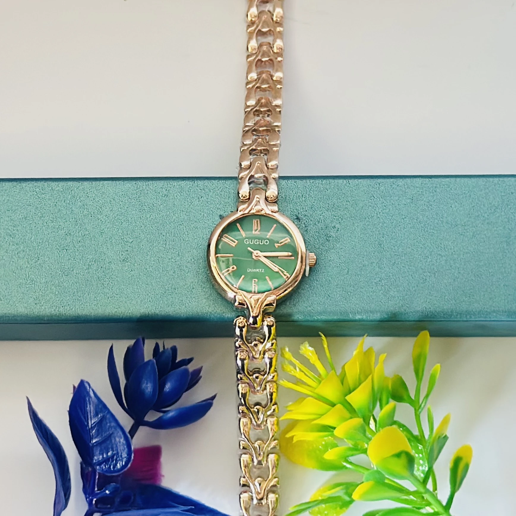 analog women's watch with a rose gold-toned metal strap.