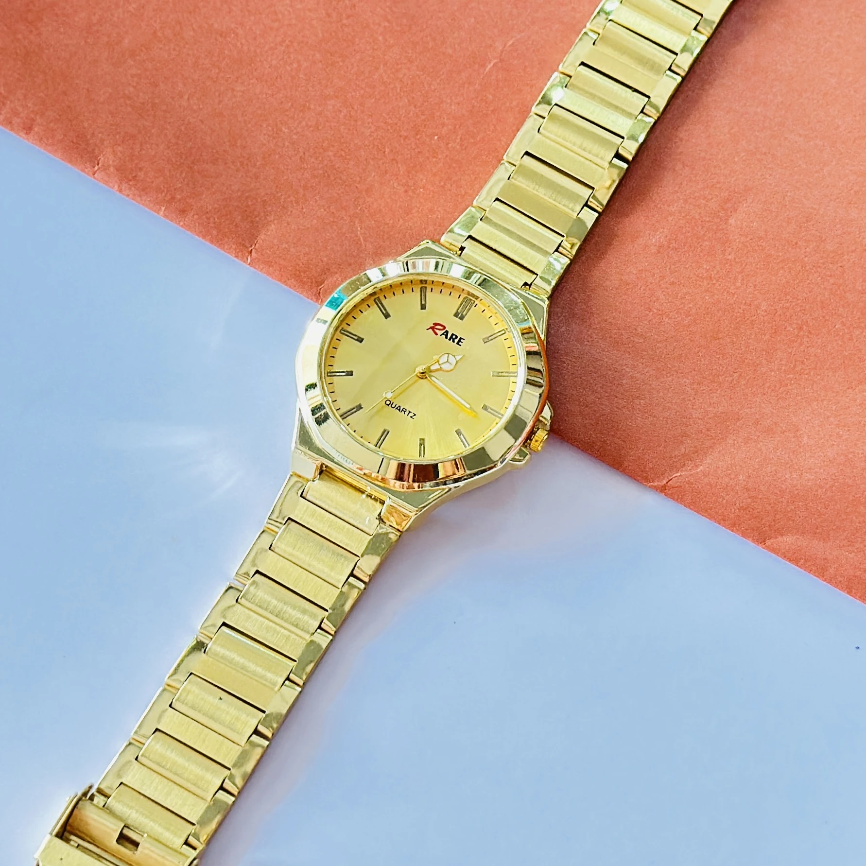 Gold coloured analogue watch