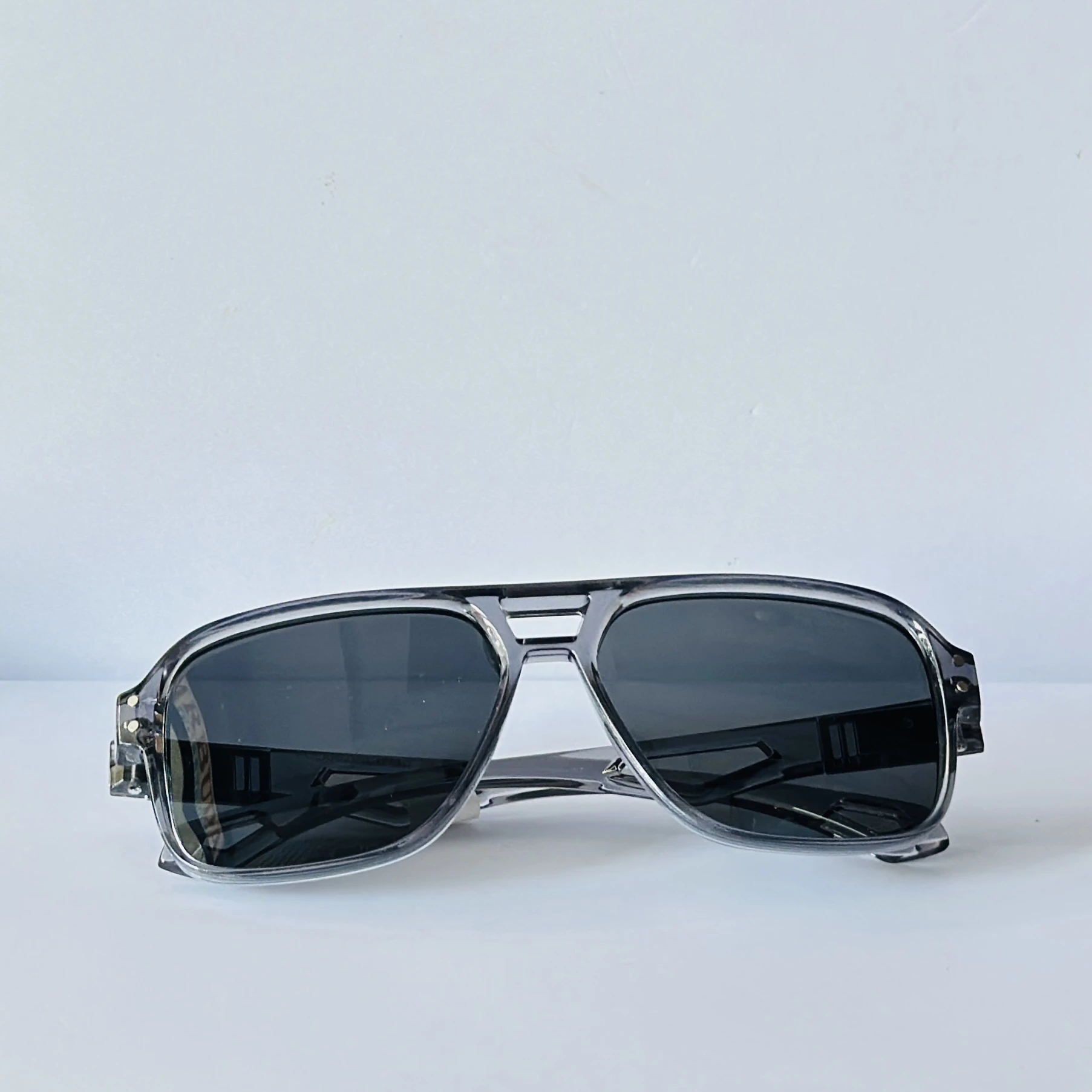 sunglasses in a transparent grey frame color.