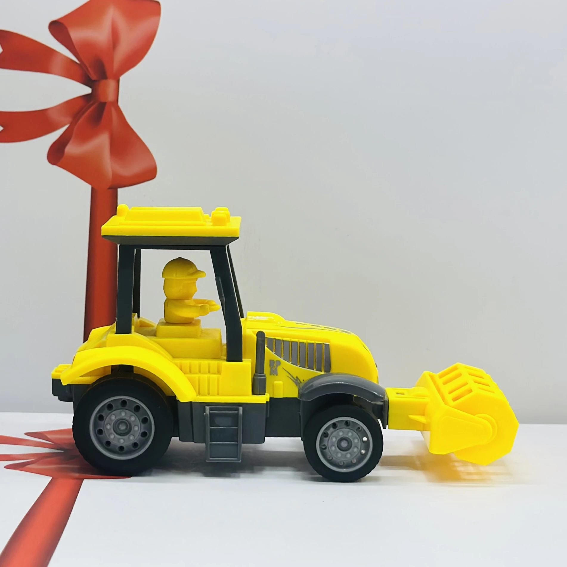 Yellow plastic toy tractor