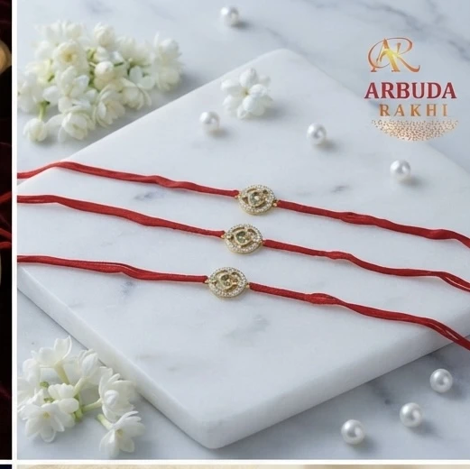 Silver Om-themed rakhis, featuring gold plating and stone studding.