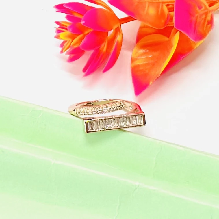 modern minimalist gold ring featuring a baguette diamond bar design.