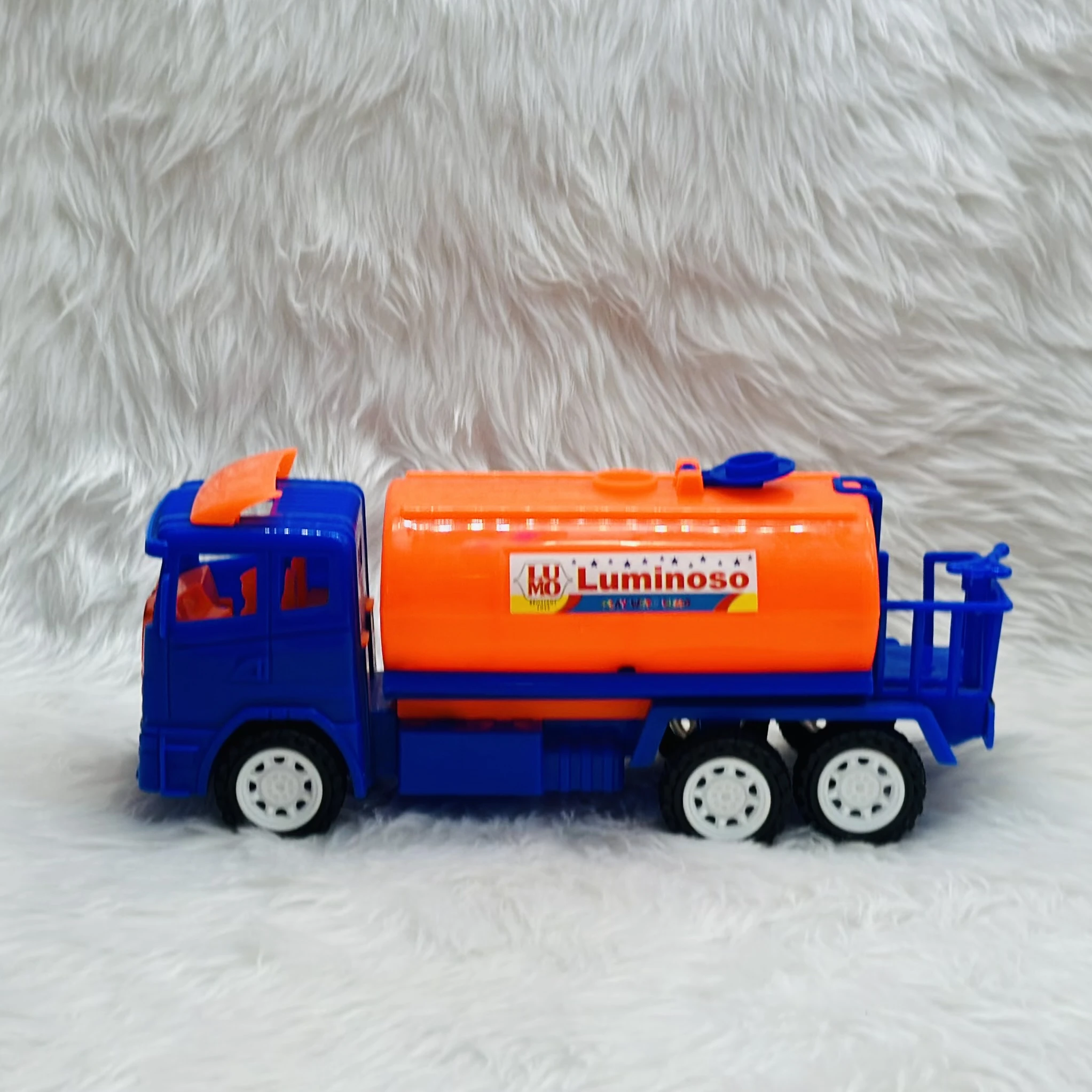 Luminoso brand friction-powered oil tanker truck toy.