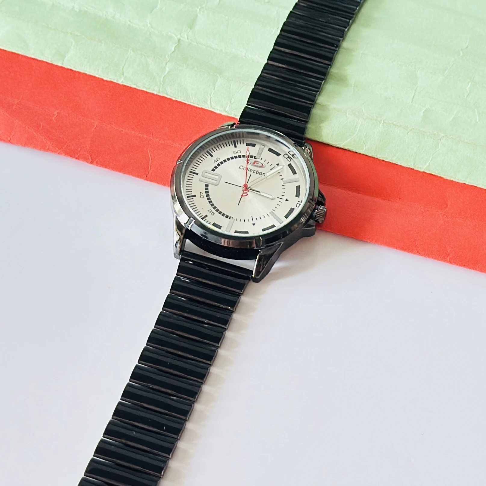 silver-toned dial and a black metal strap
