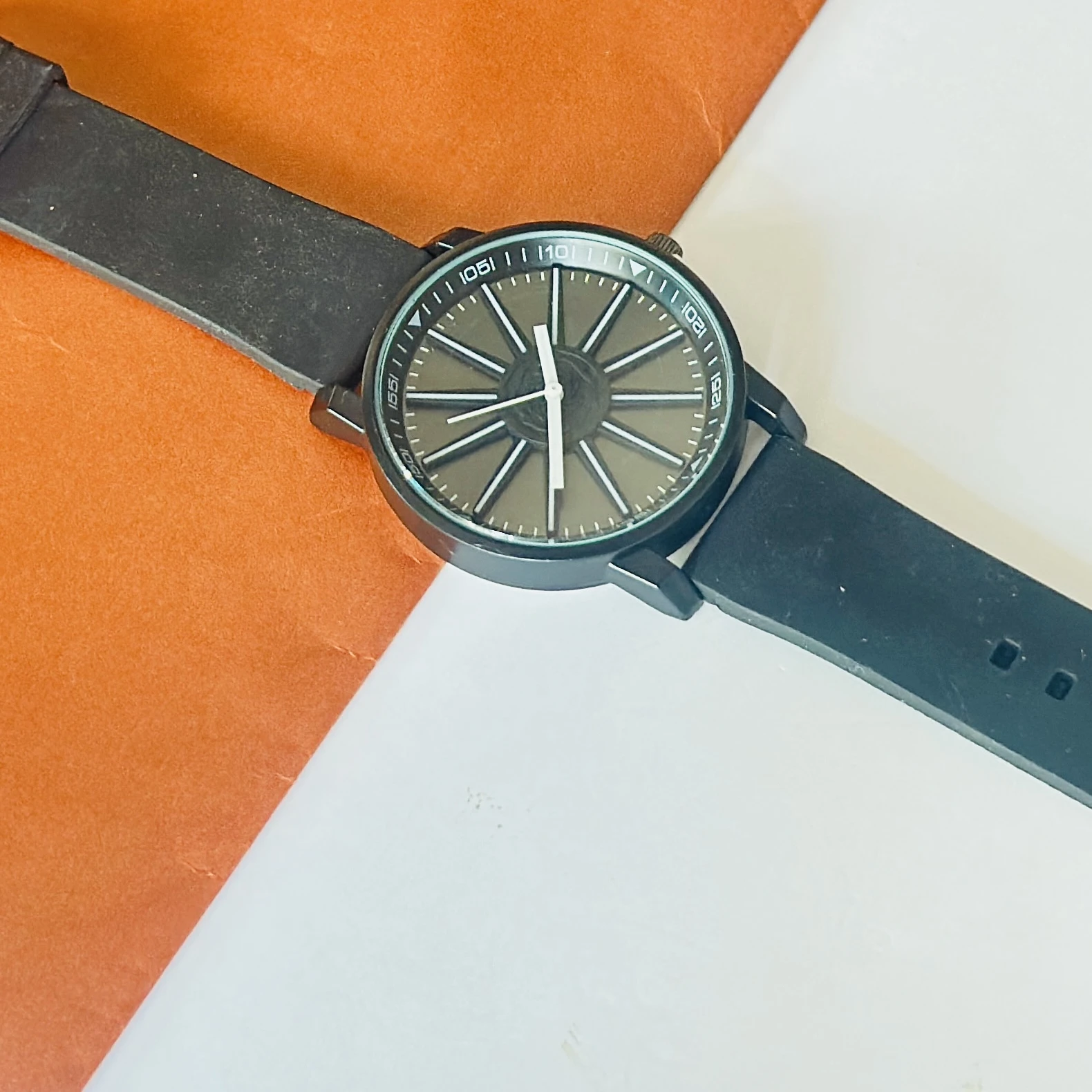 watch appears to be a V9 Collection black analog wristwatch with a silicone strap.
