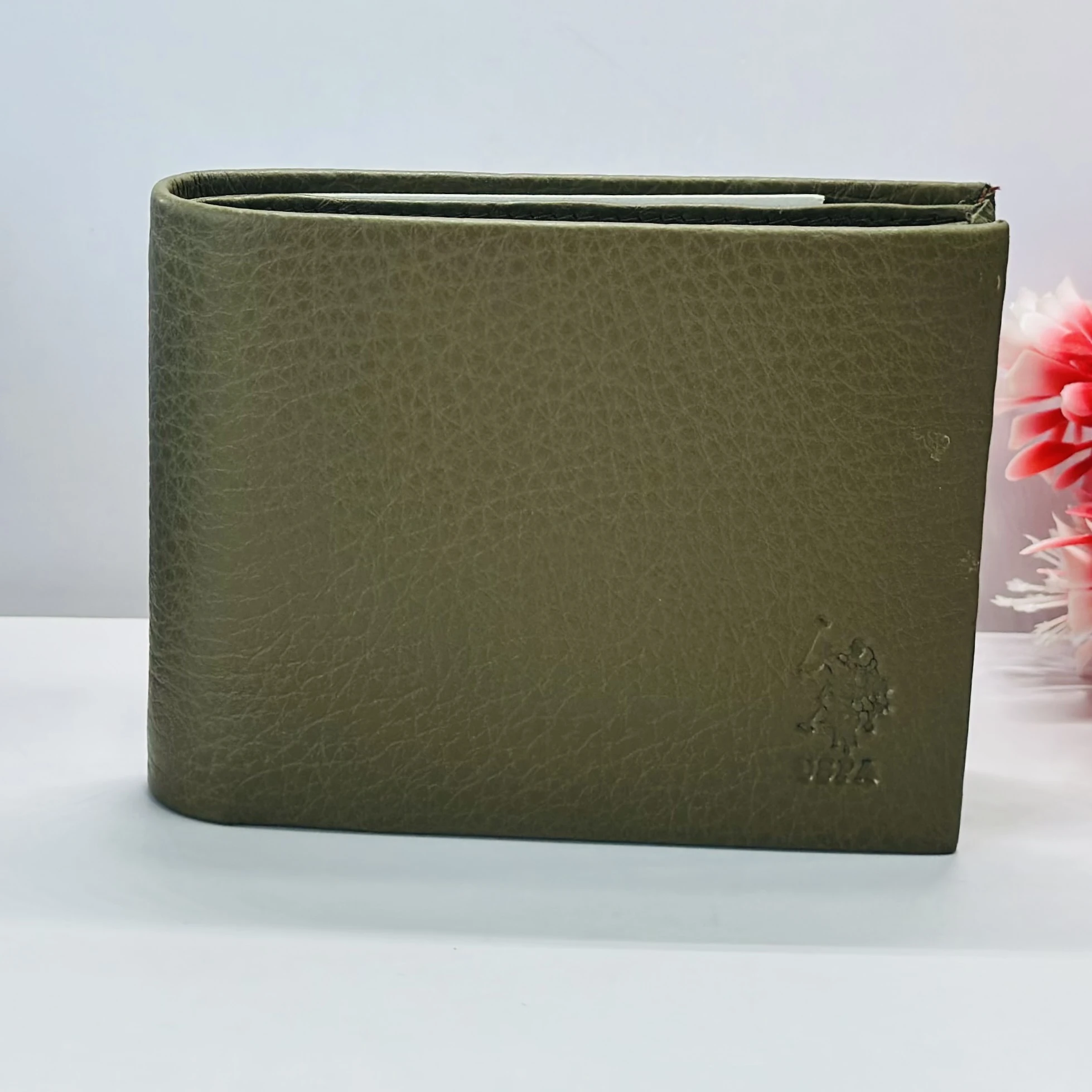 U.S. Polo Assn. men's bi-fold wallet in olive green grained leather.