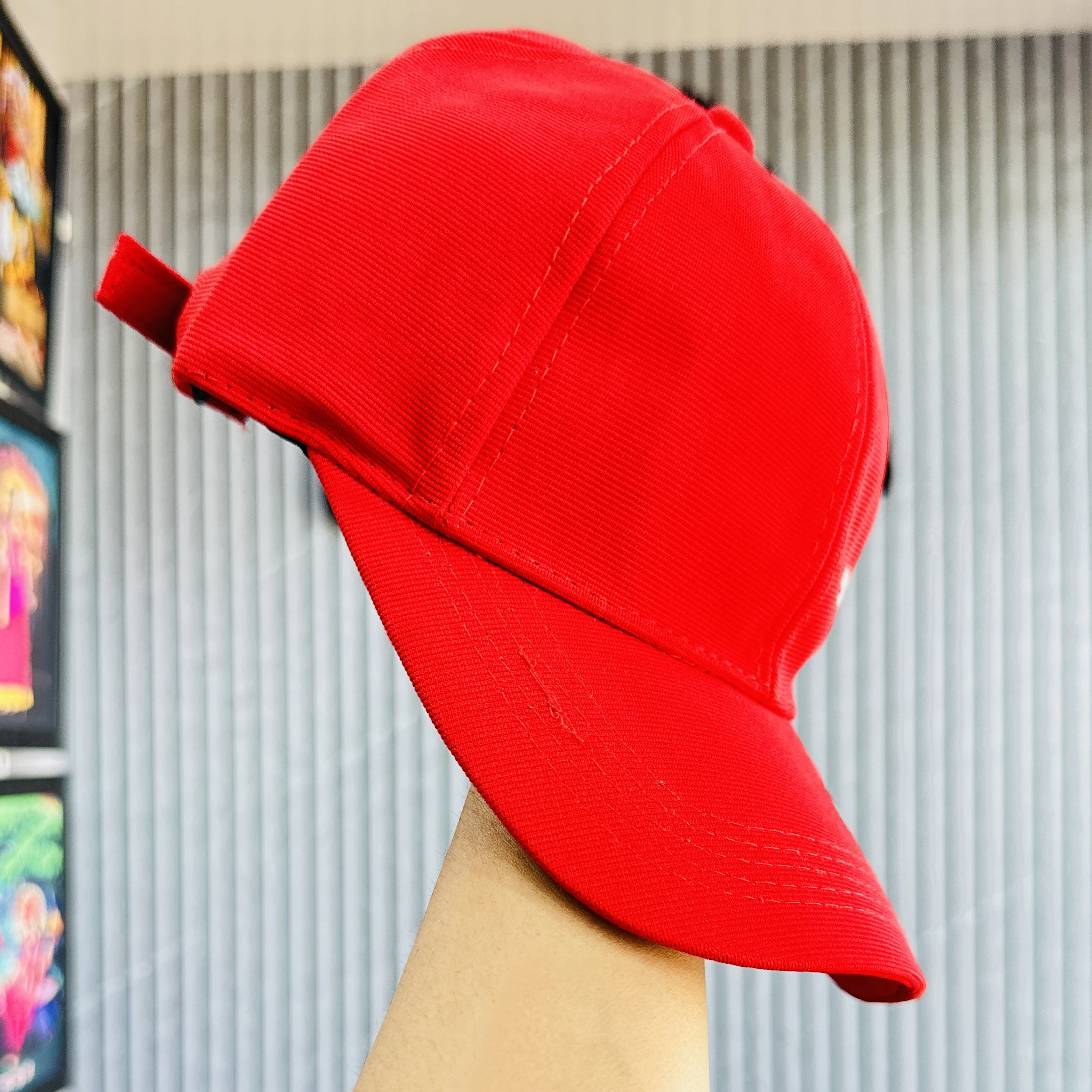 appears to be a red baseball-style cap