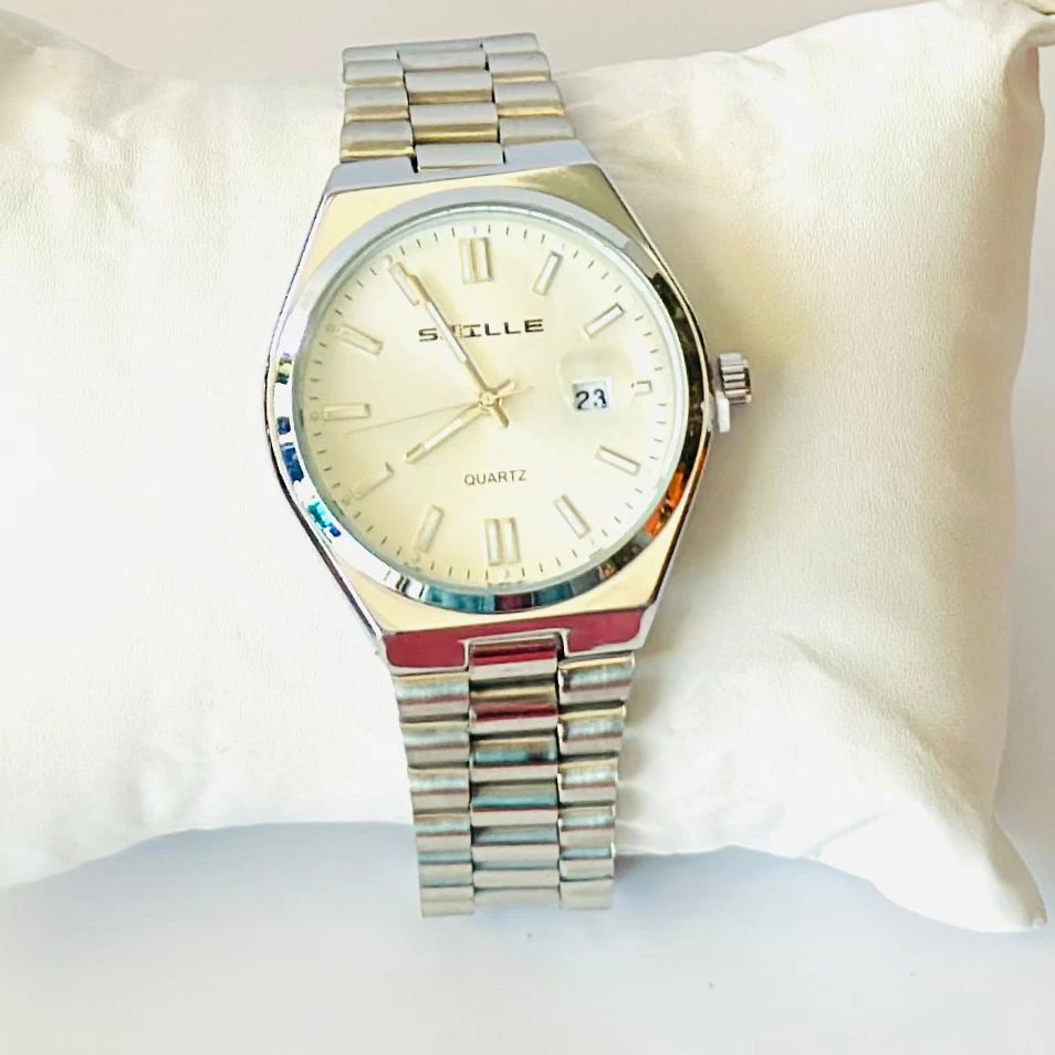 Snille analog quartz watch with a white dial and silver stainless steel strap.