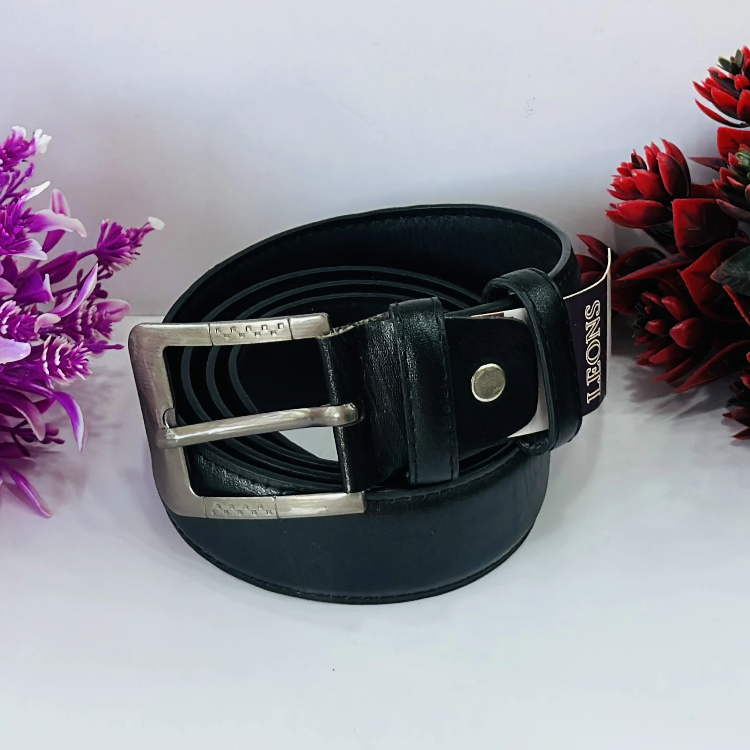 Men’s black leather belt with a metal buckle.