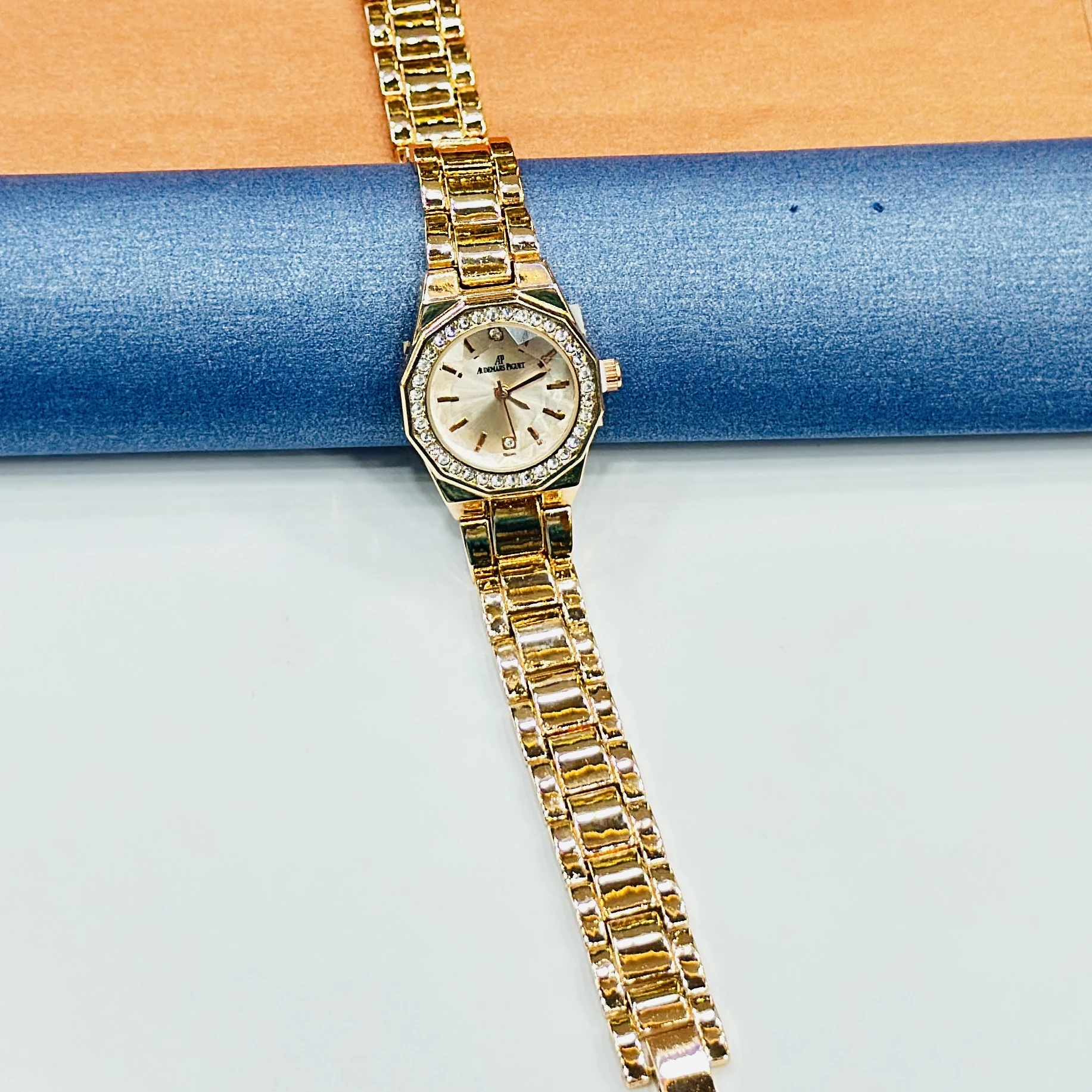 gold-tone ladies' watches with a sparkling bezel and metallic strap