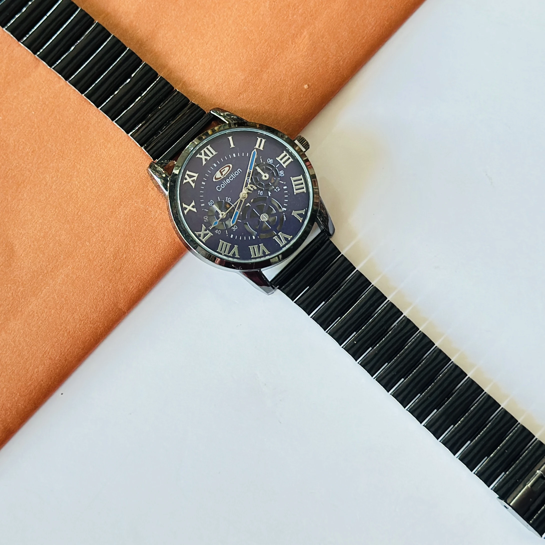 Black stainless steel OLEVS analog watch for men with a blue roman numeral dial.