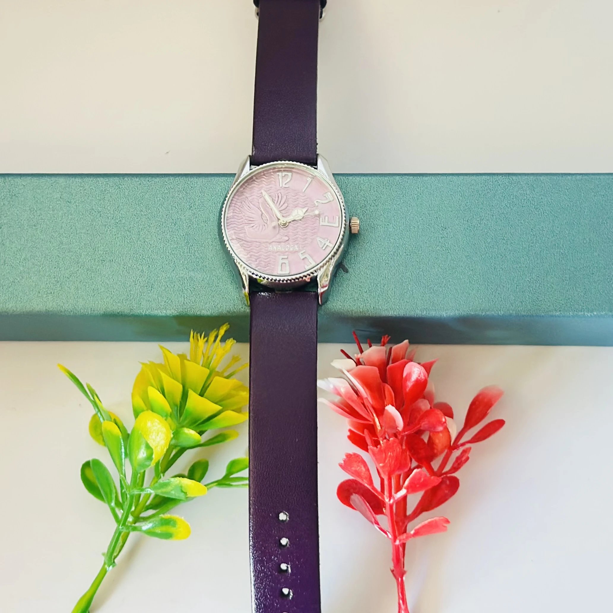 Sure Shot analog watch with a black leather band and silver-tone case.