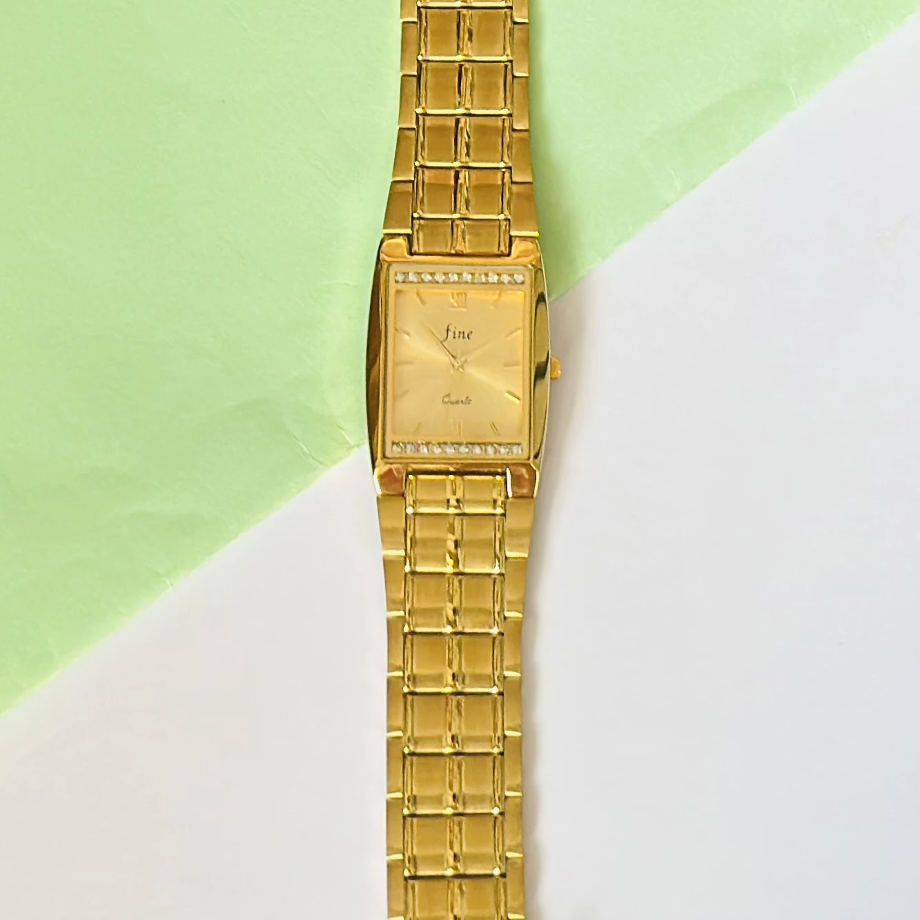 Gold plated stainless steel analog quartz watch.
