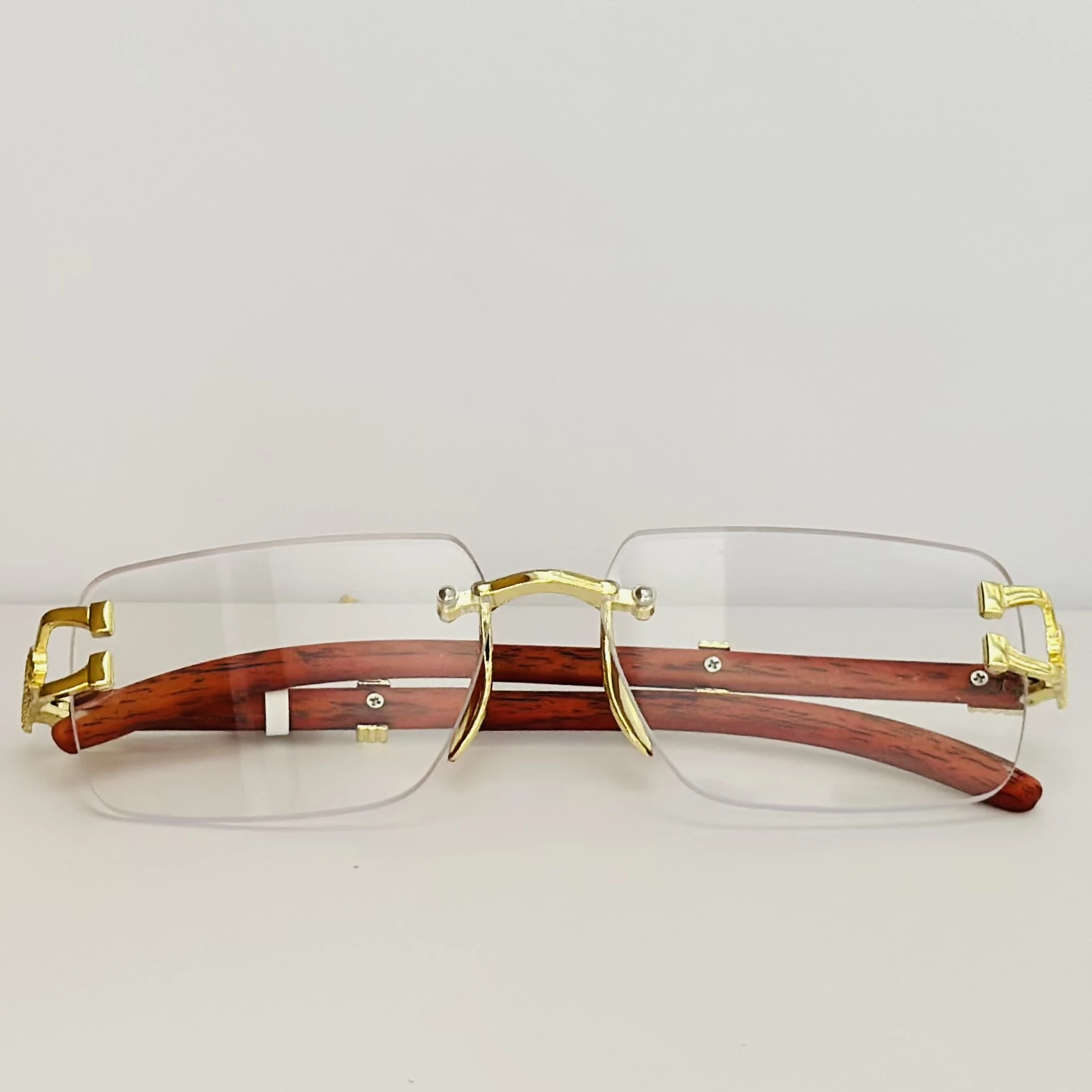 Street Knitted men's rimless gold frame glasses with clear lenses and a woodgrain finish on the arms.