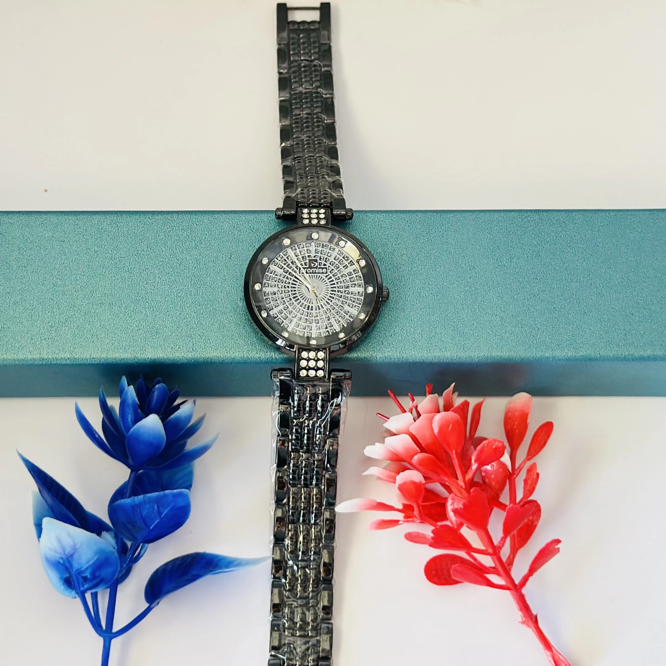 Ladies fashion watch with a black metal strap.