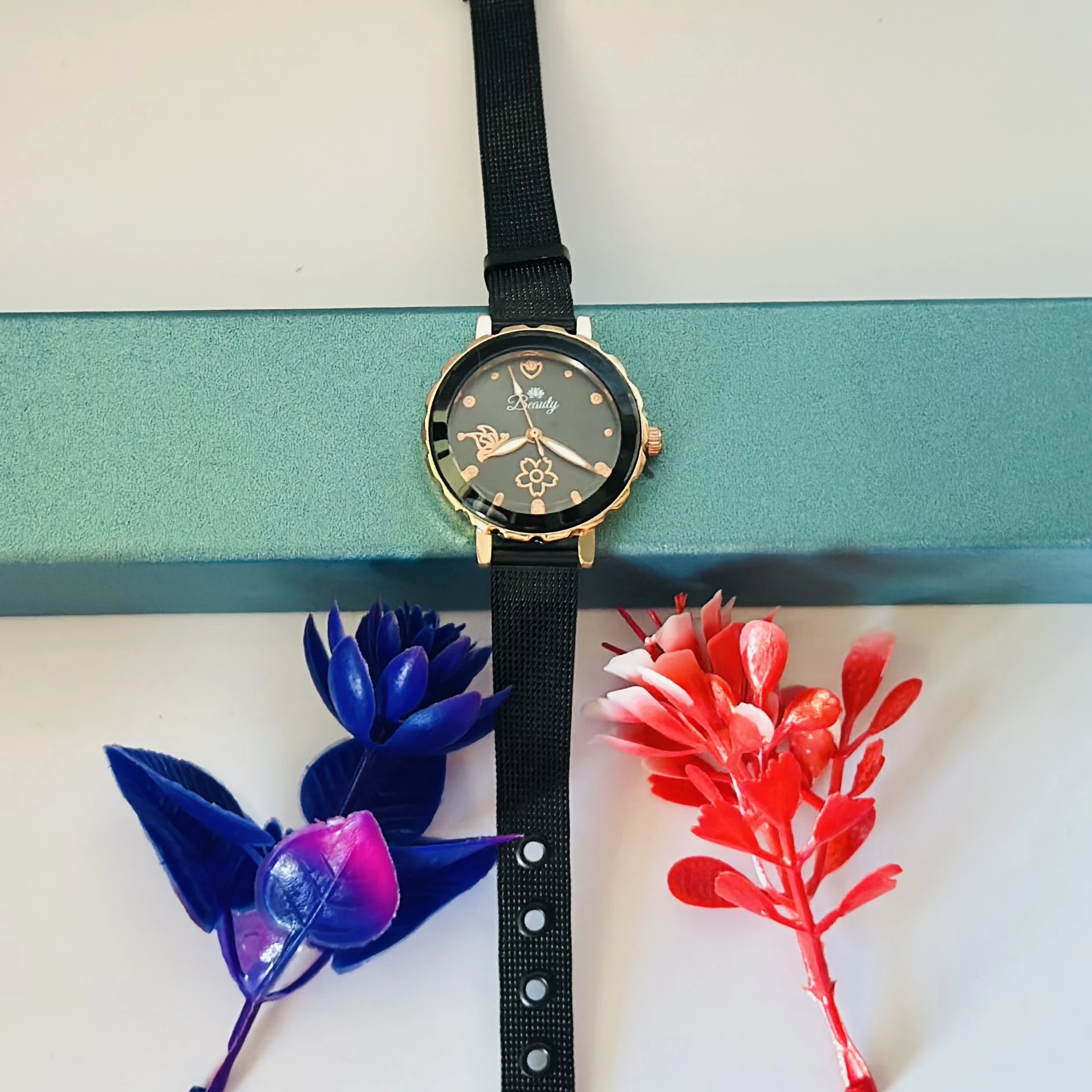 analog watch with a black magnetic strap