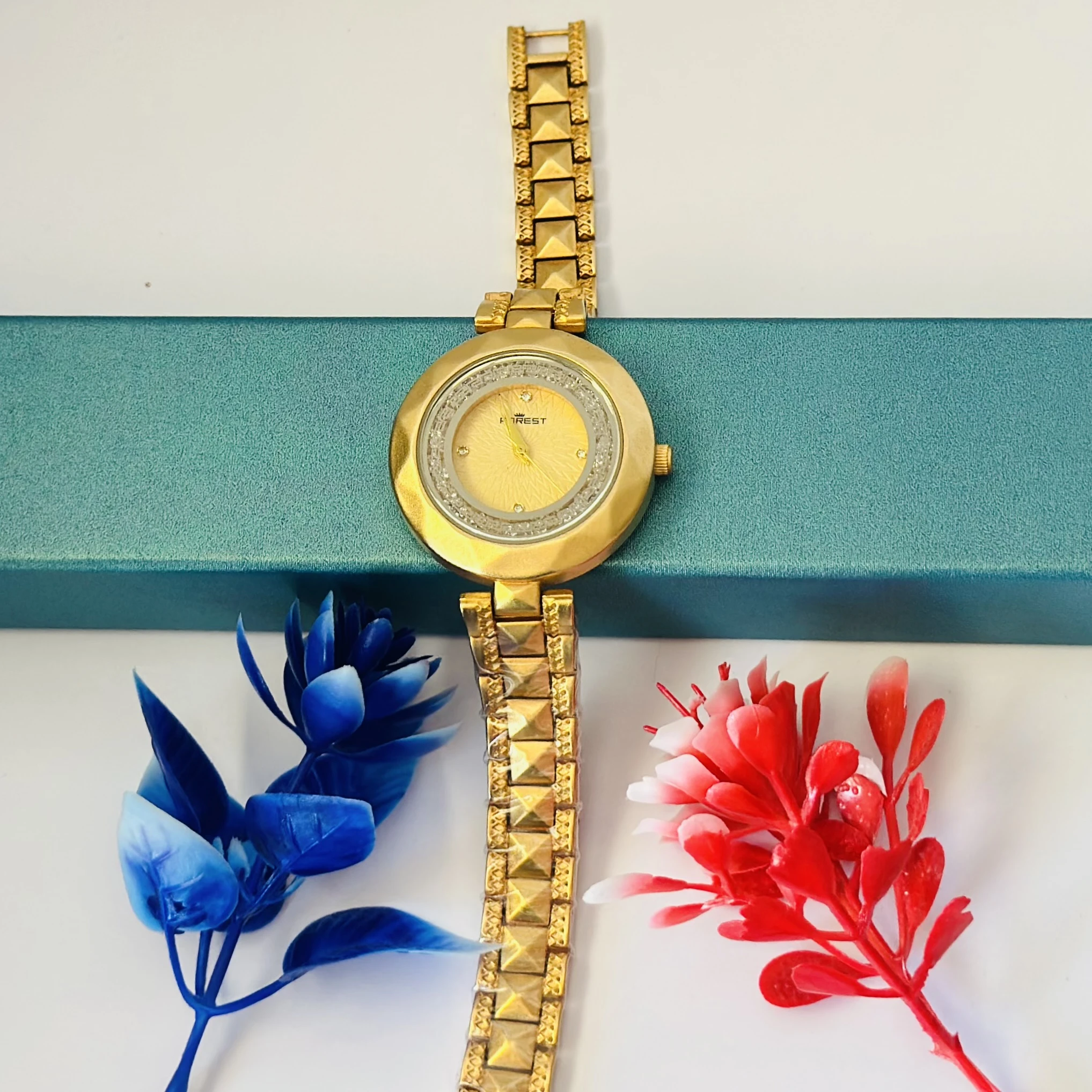 analog watch for women with a golden dial and band.