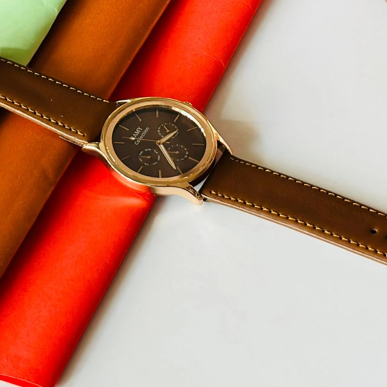 Round analog watch with a brown leather strap