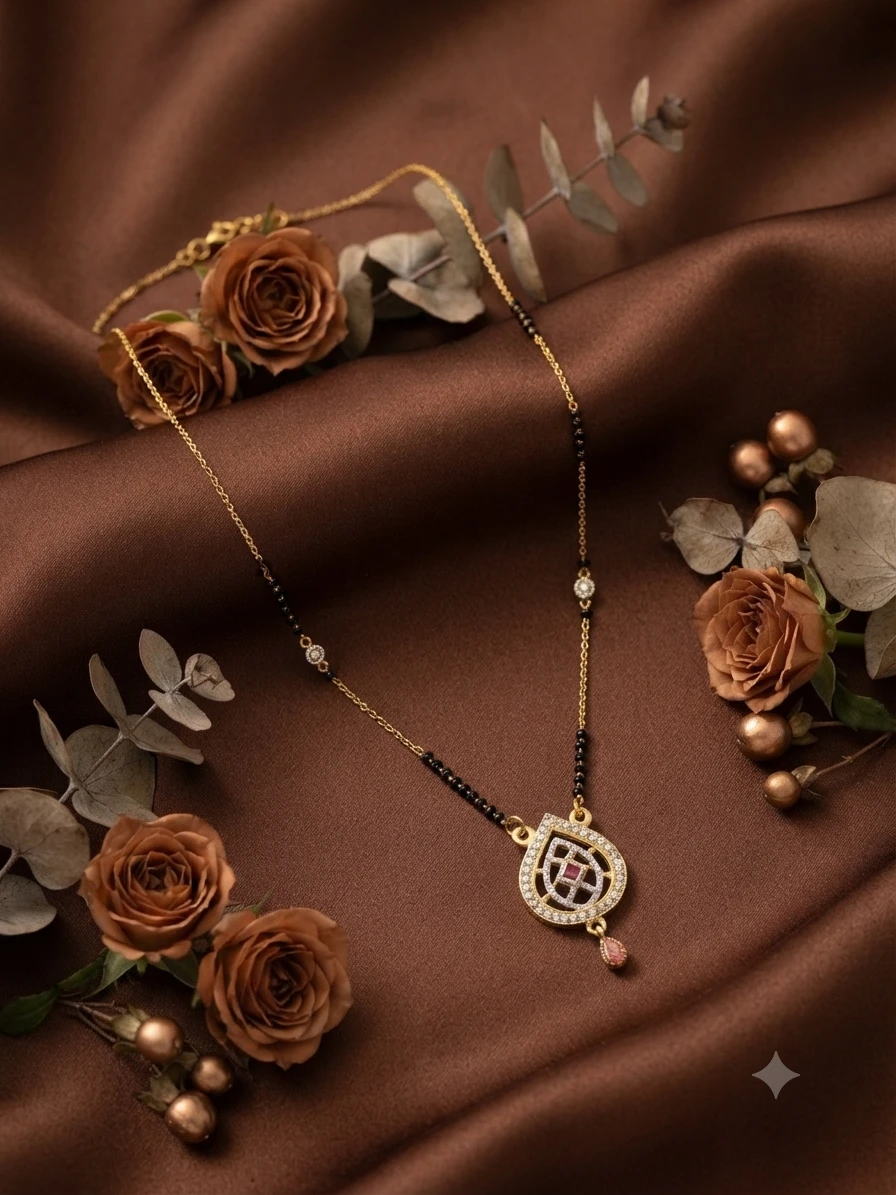 gold-plated mangalsutra features black beaded chains and a pendant