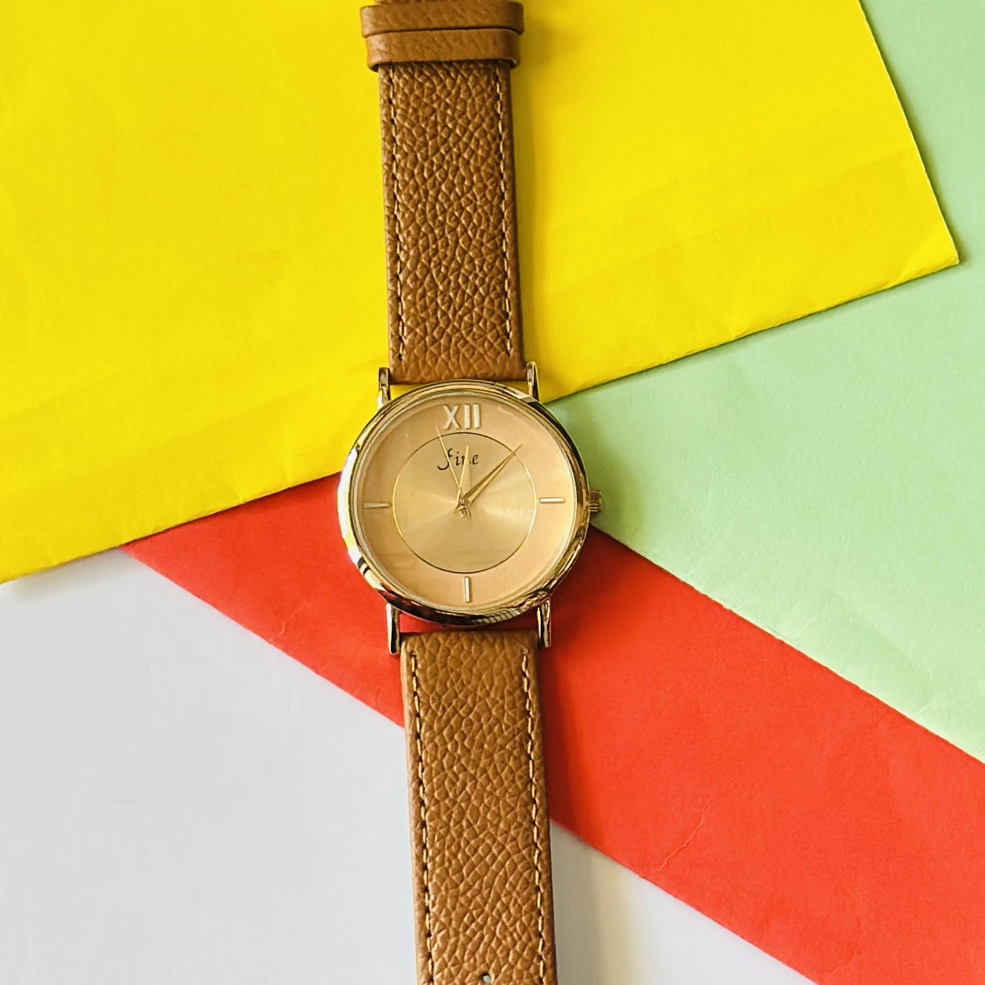 Jule Sun-Kissed watch with a tan faux leather strap and gold-toned details.