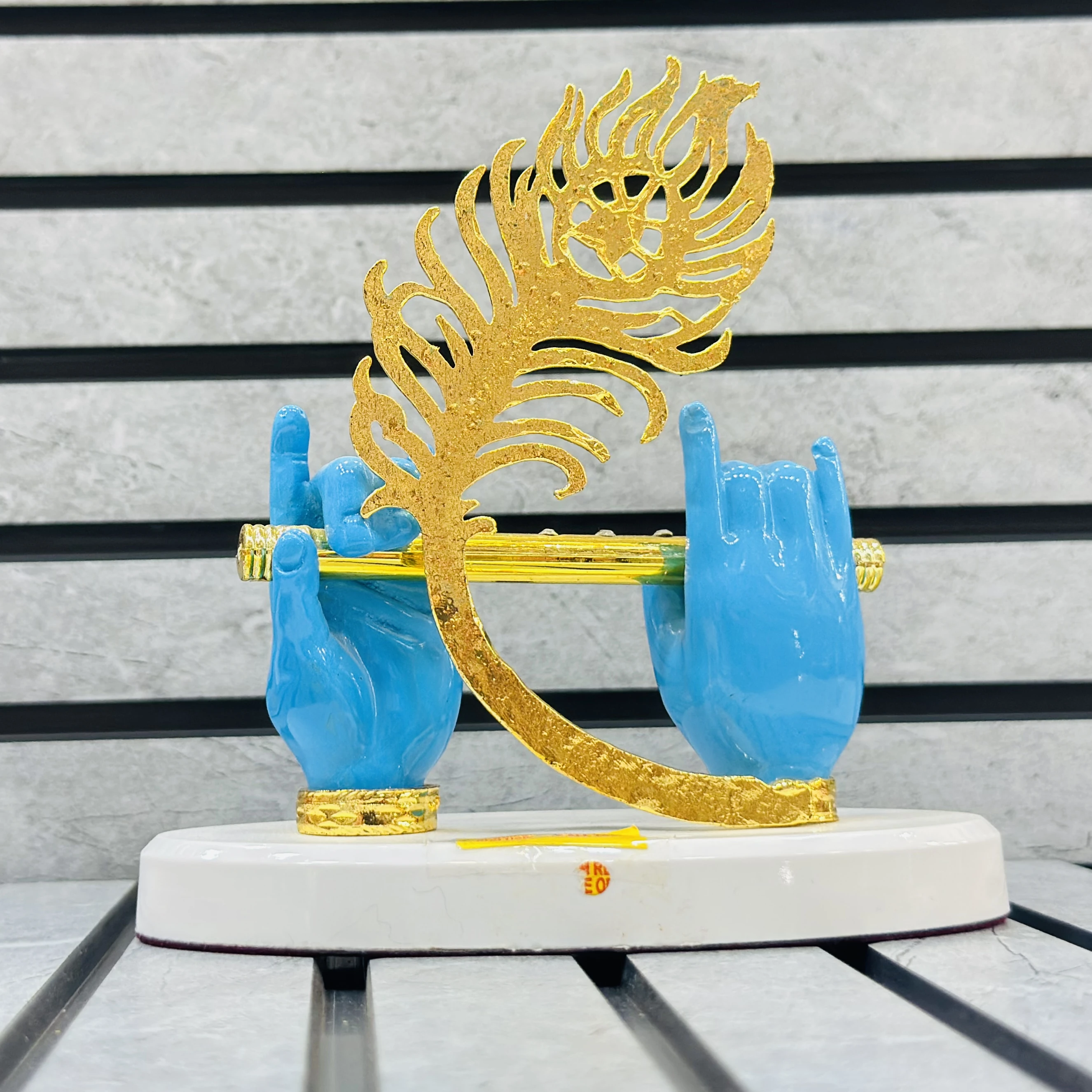 Gold plated Lord Krishna hands with flute and peacock feather figurine.