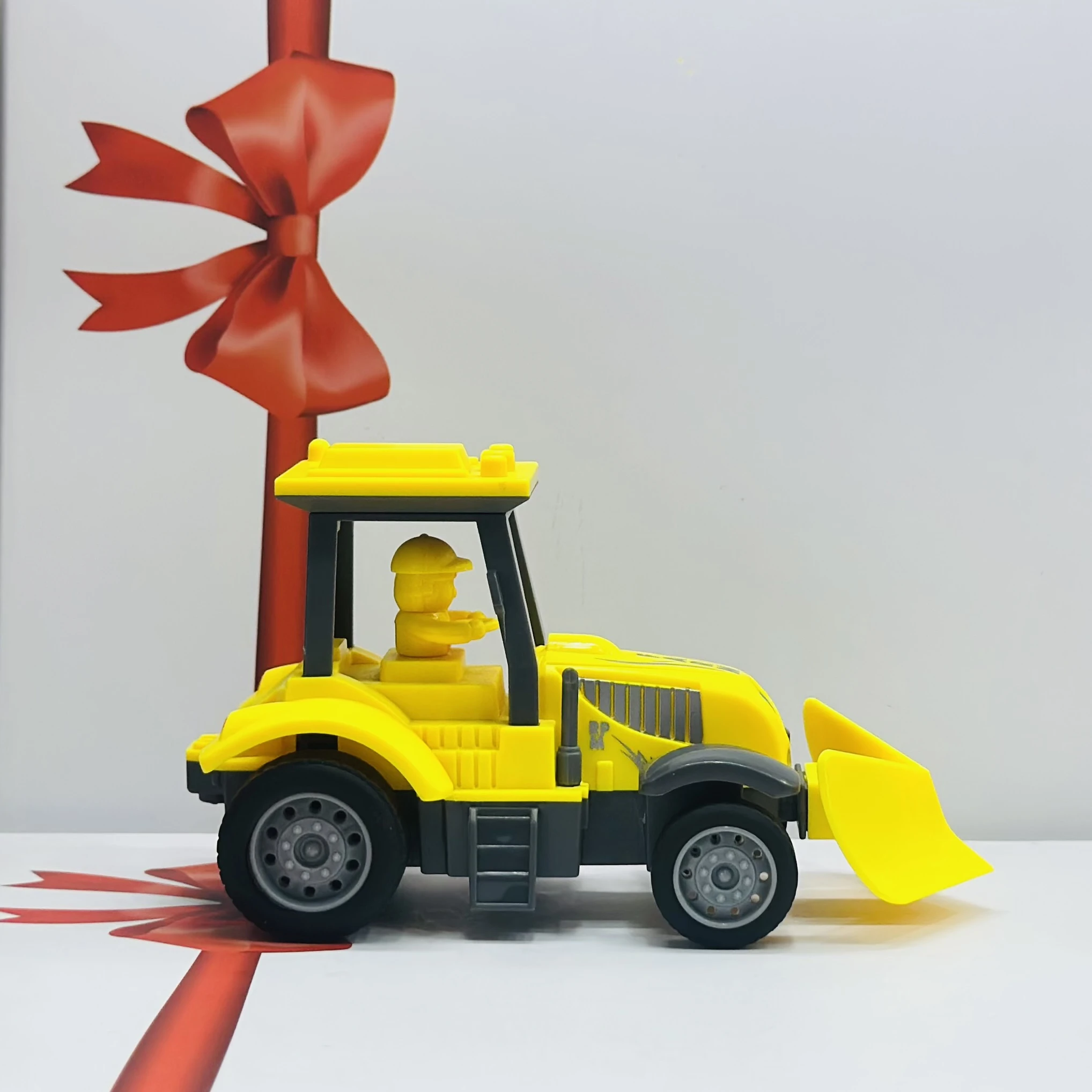 Yellow plastic toy tractor