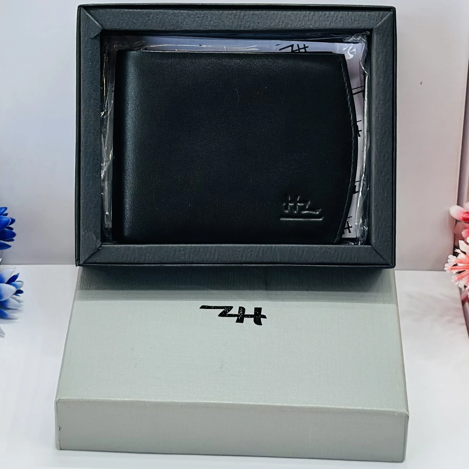 Black genuine leather bifold men's wallet.