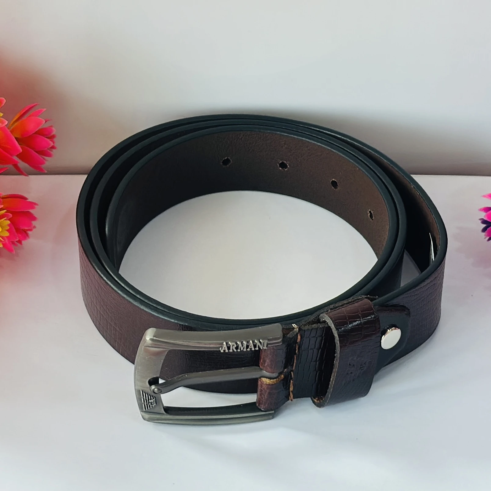 Brown Armani leather belt with a silver-tone buckle.