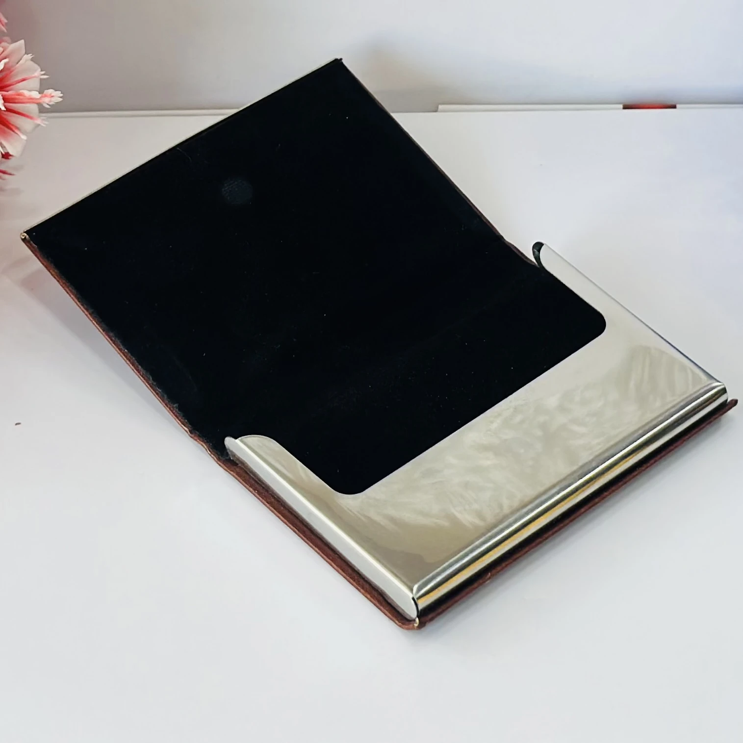 business card holder or card case, likely made of PU leather and stainless steel.